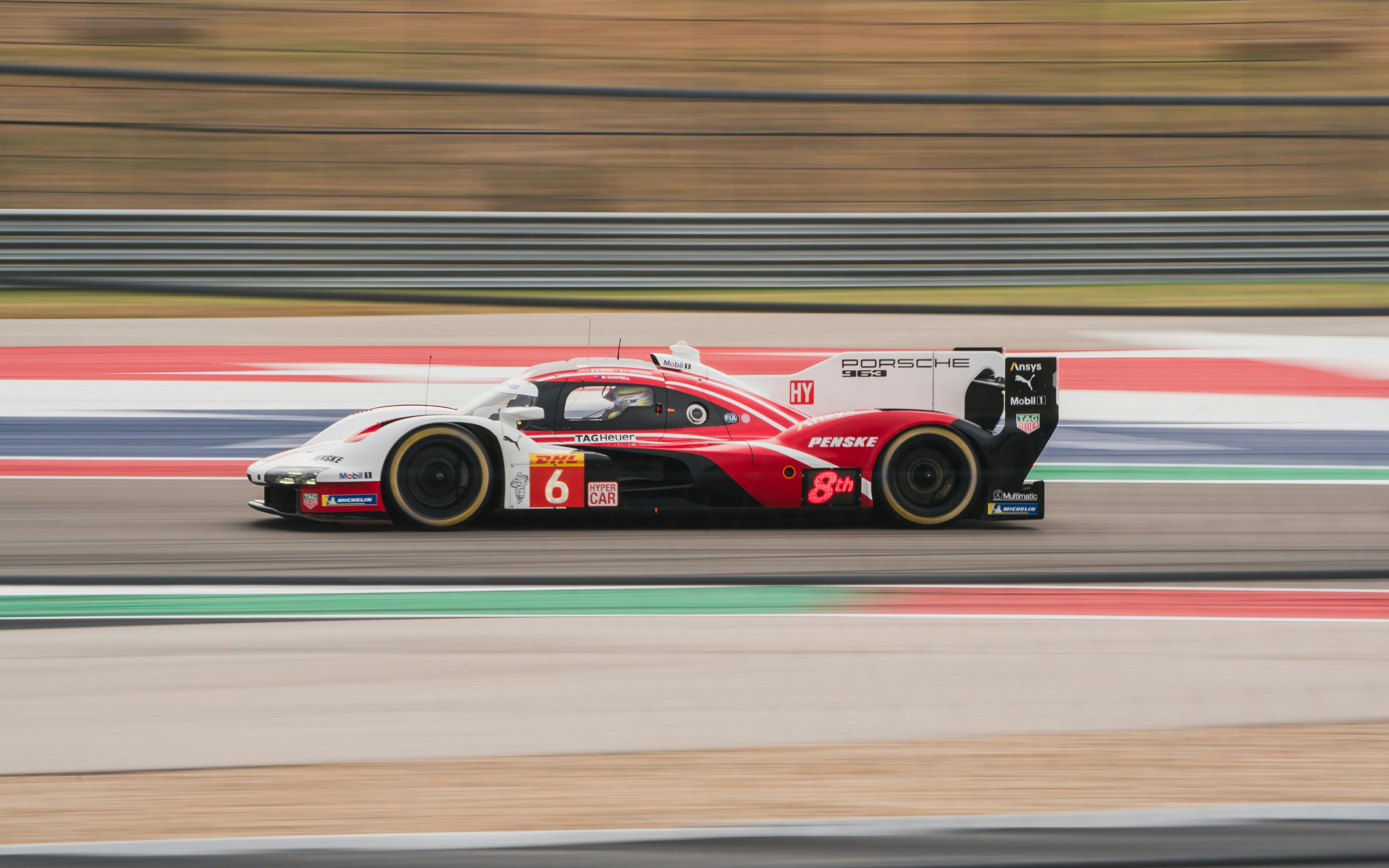 Race car speeding down a track with motion blur
