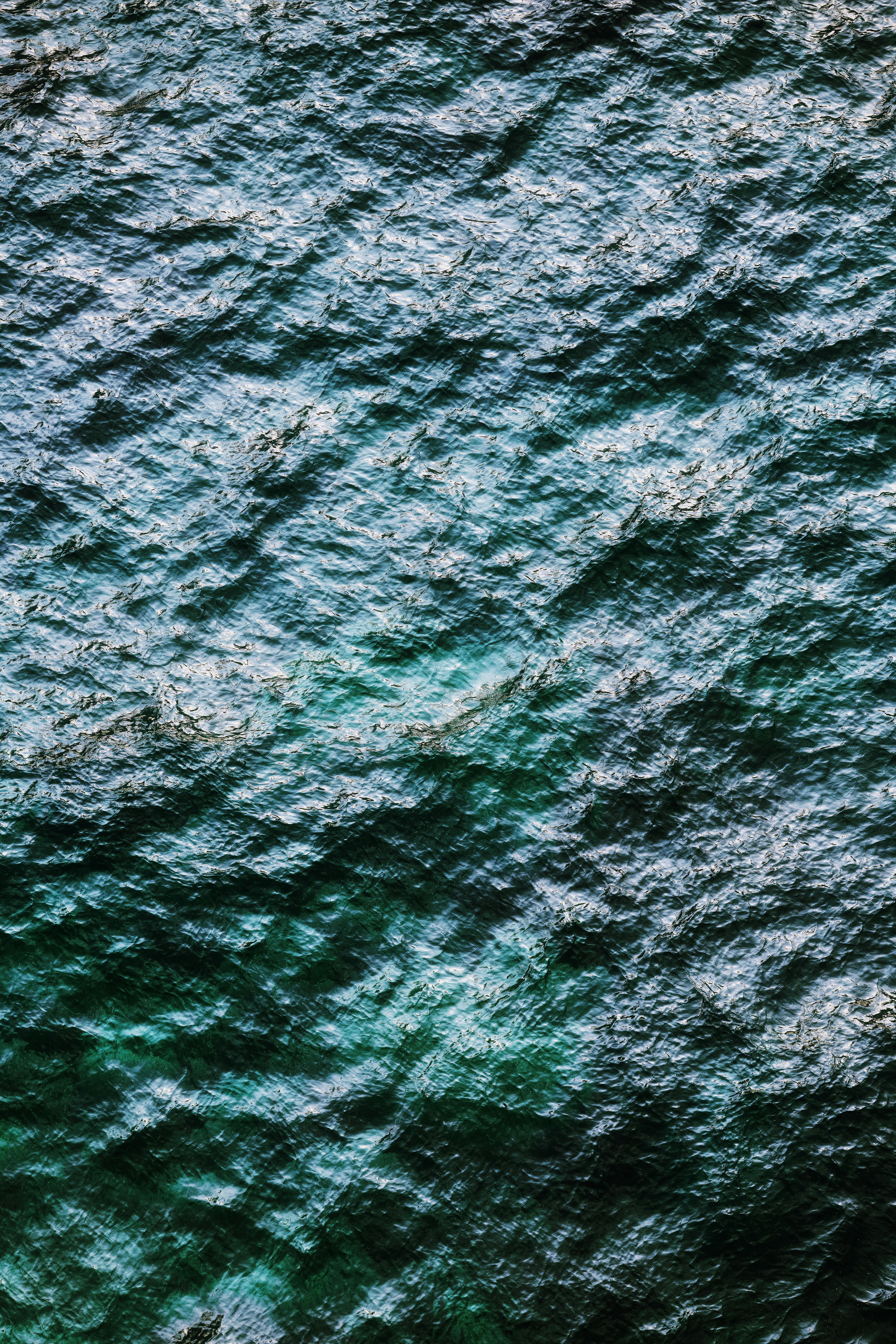 Rippling dark blue water surface from above