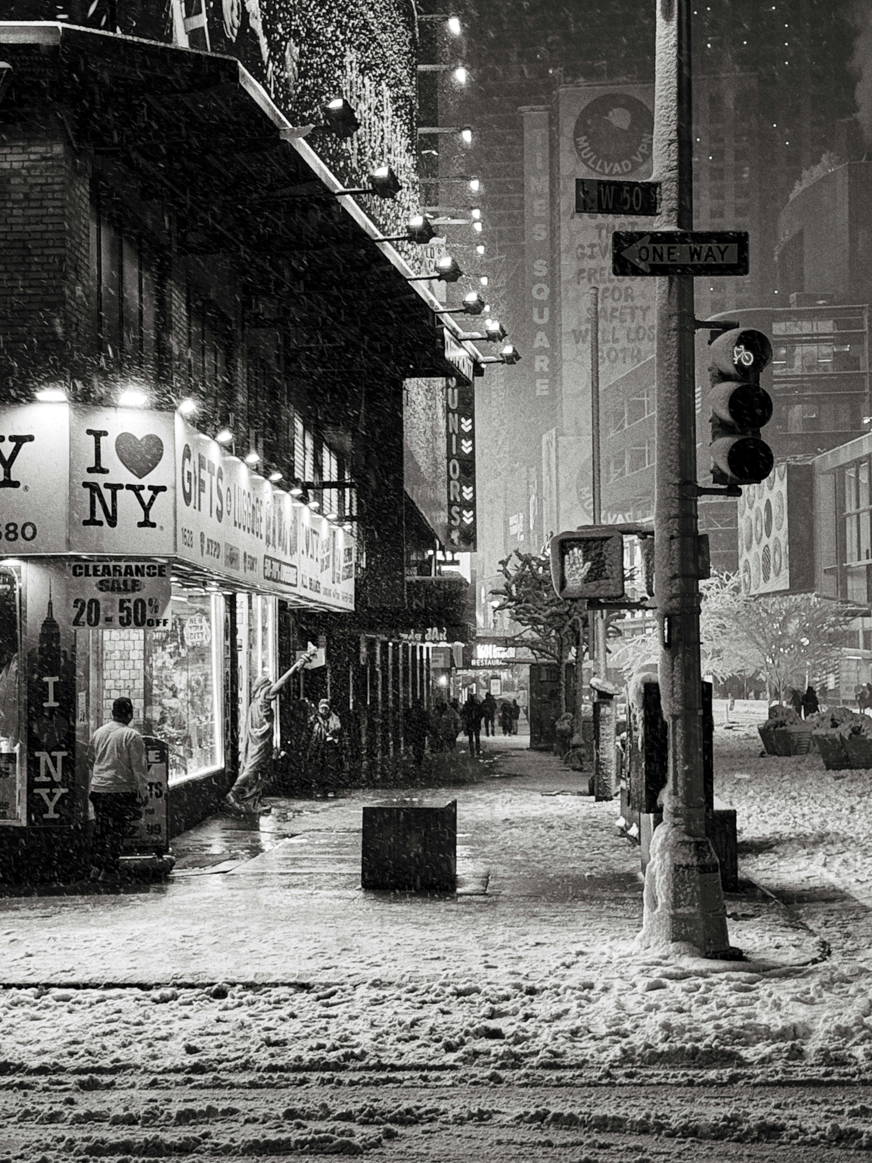 Snowfall on a city street at night