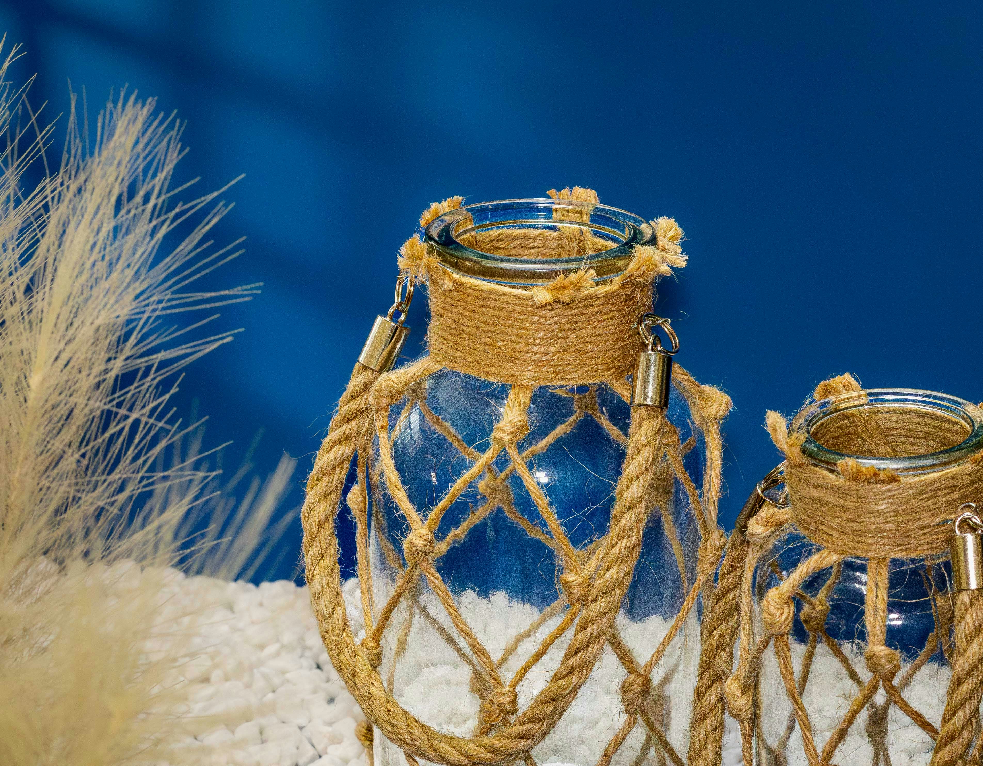 Two glass jars wrapped in rope netting