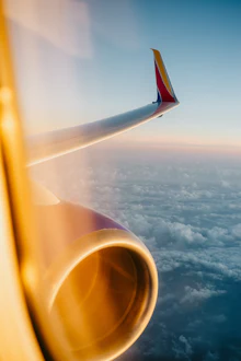 An airplane wing seen against the sky