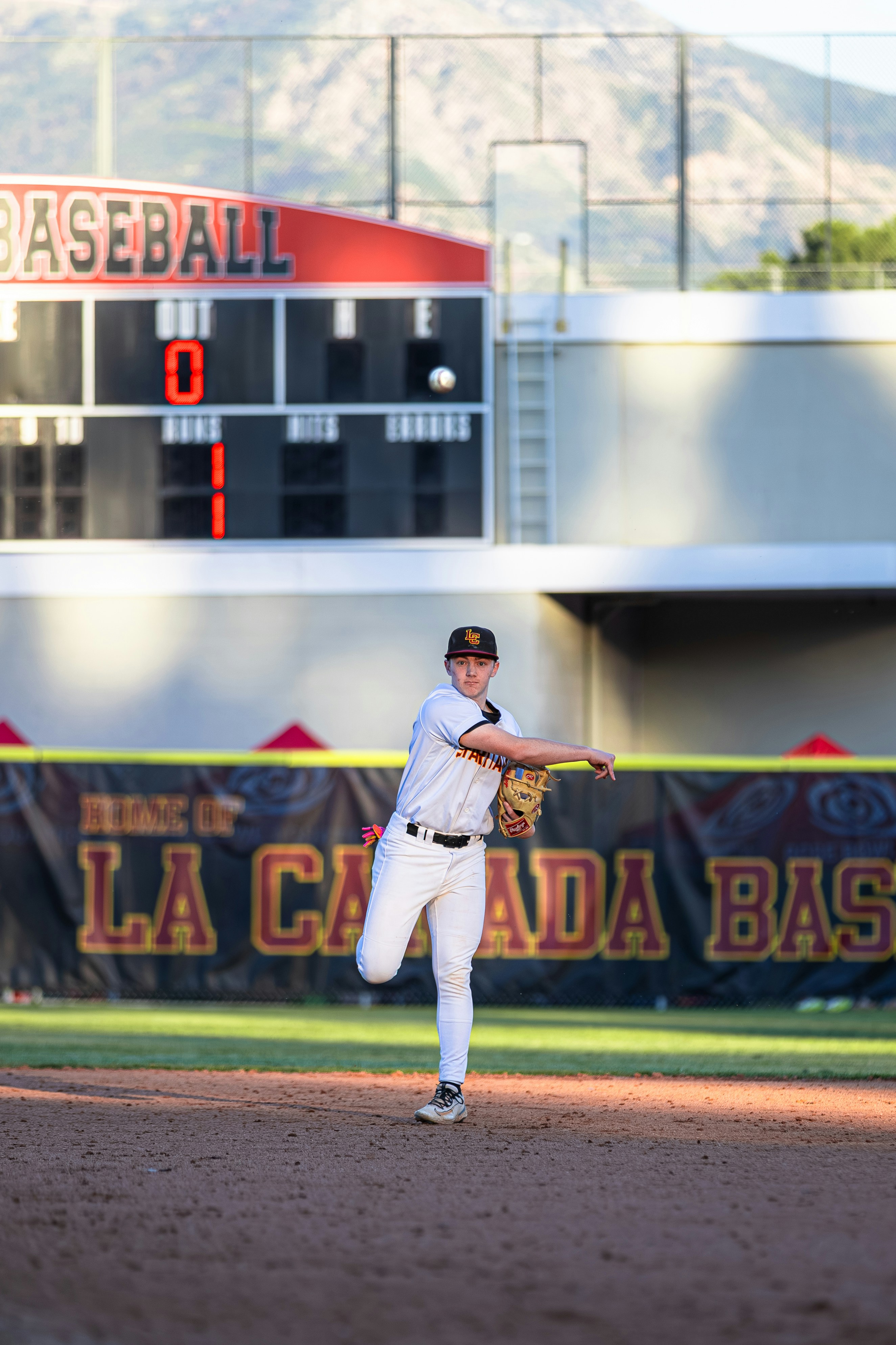 Young baseball player throwing a ball on the field.