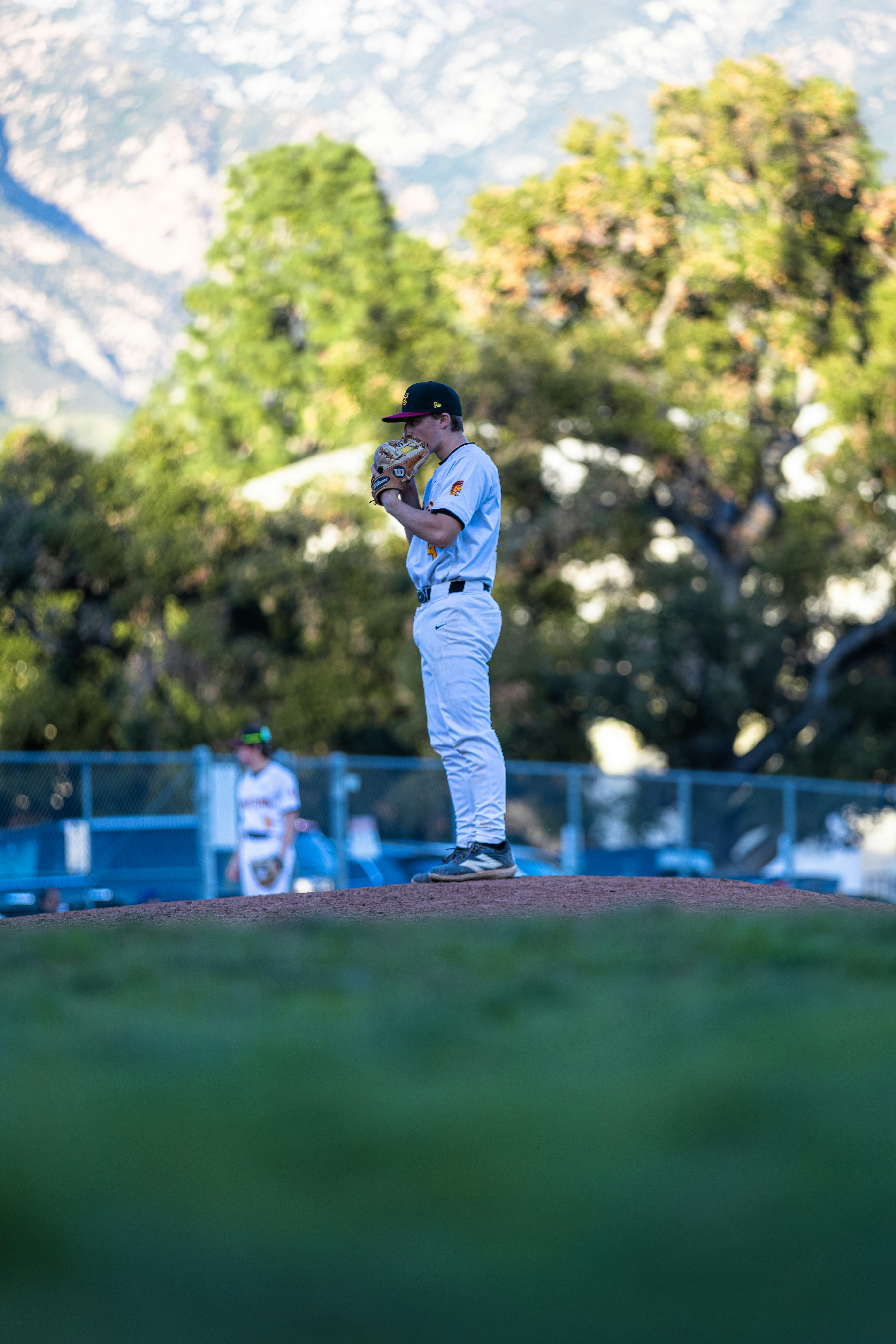 A baseball pitcher on the mound preparing to throw.