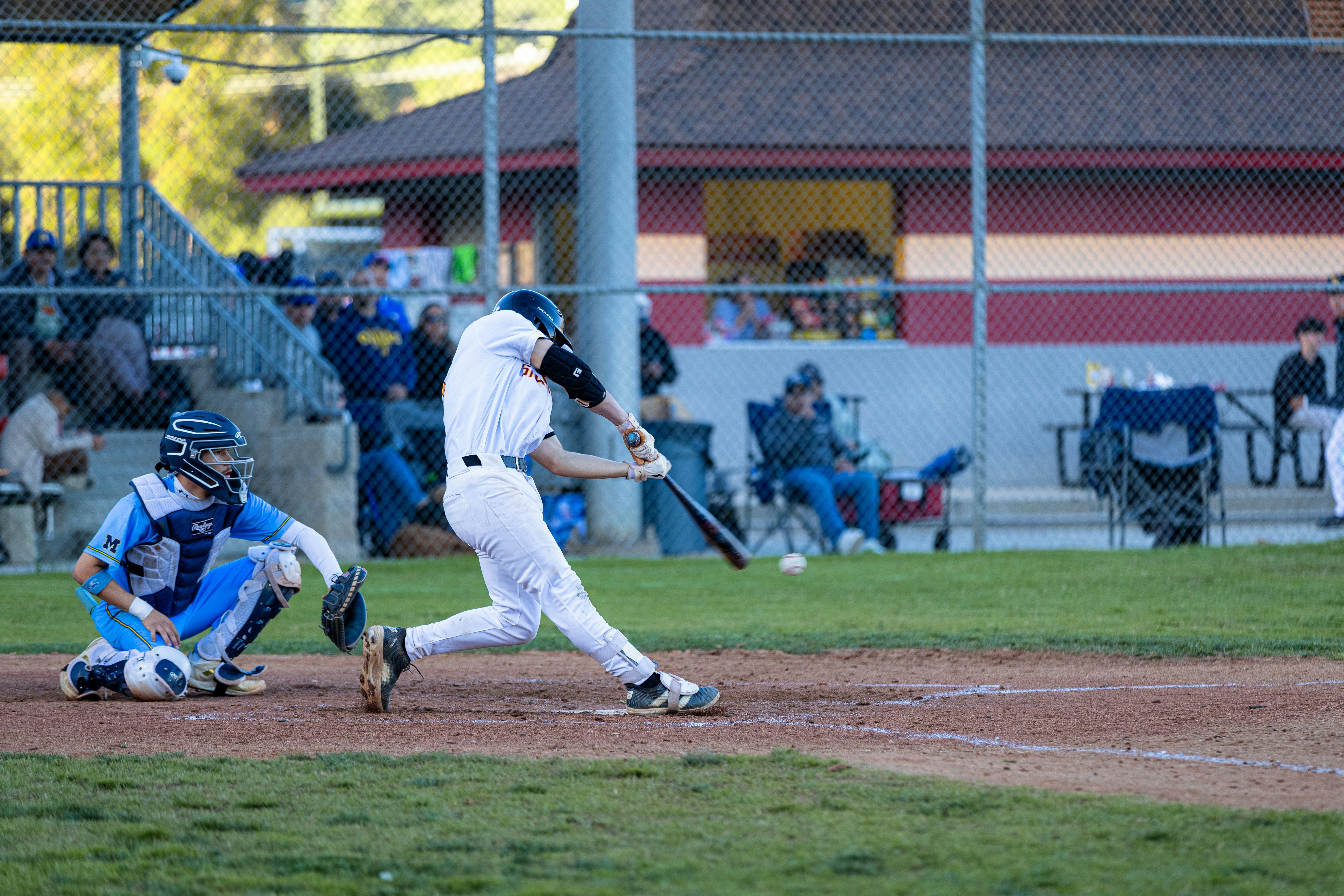 Baseball player swings bat at a game