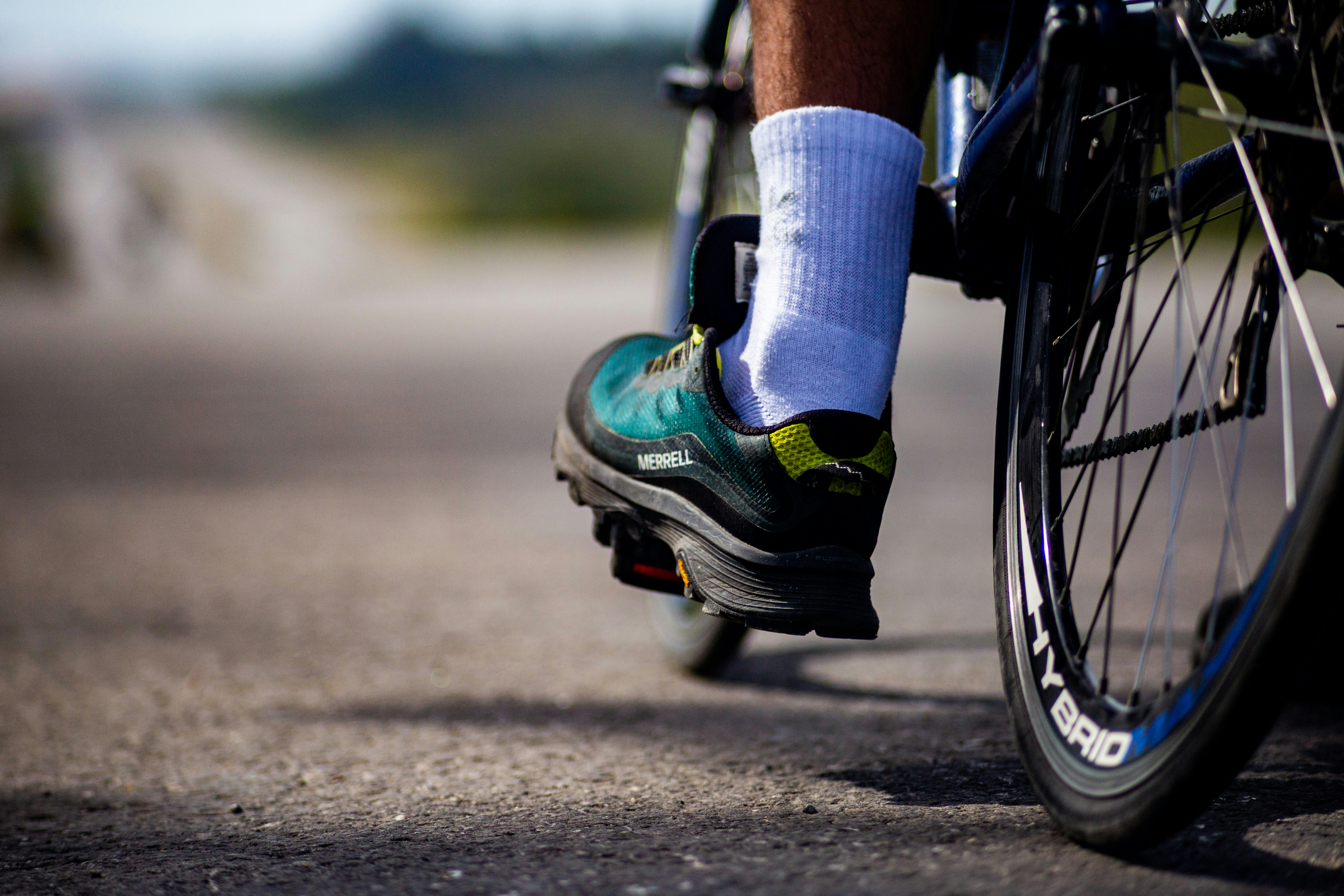 Cyclist's foot on pedal, riding on road