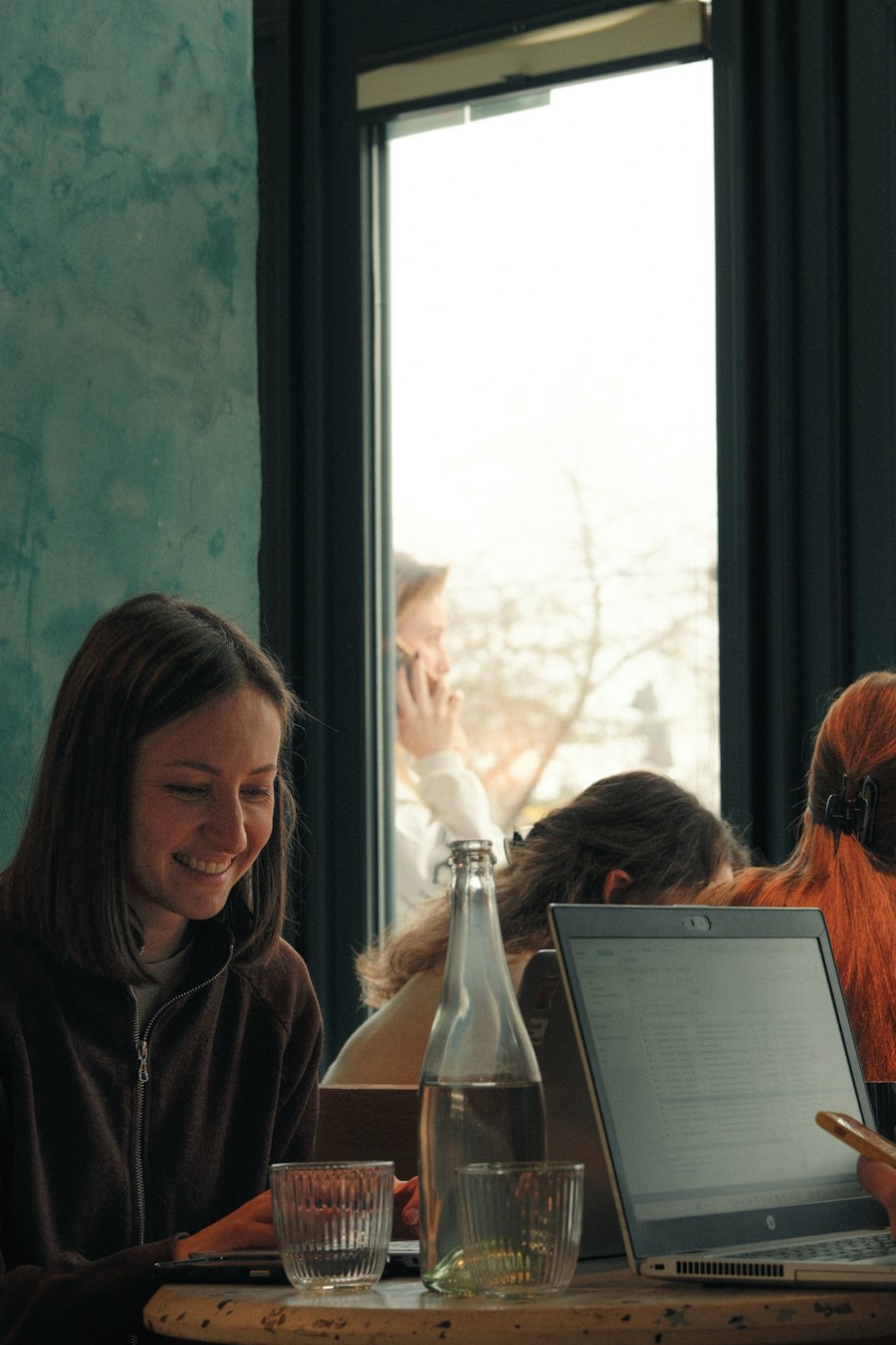 Student smiling while working on a laptop