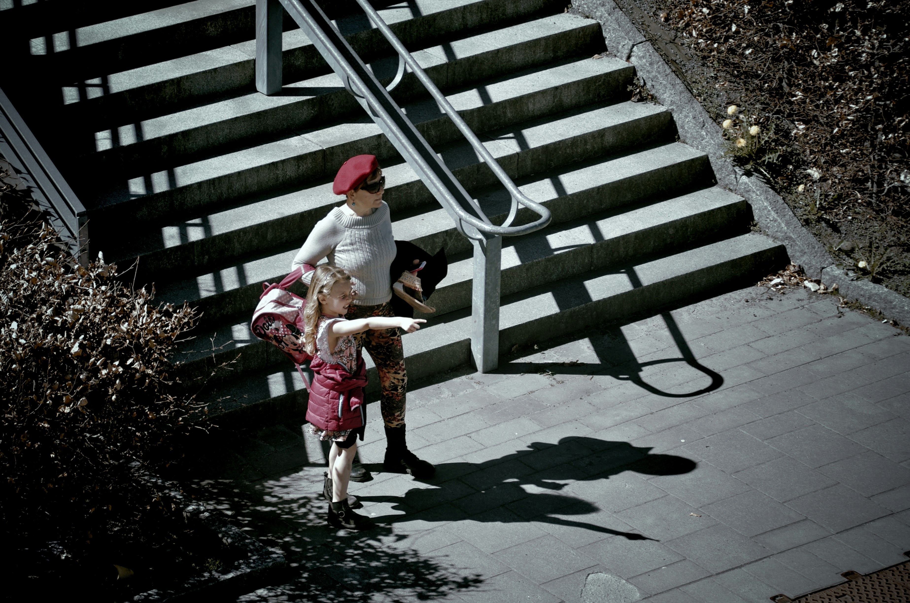 Woman and child walking down outdoor stairs