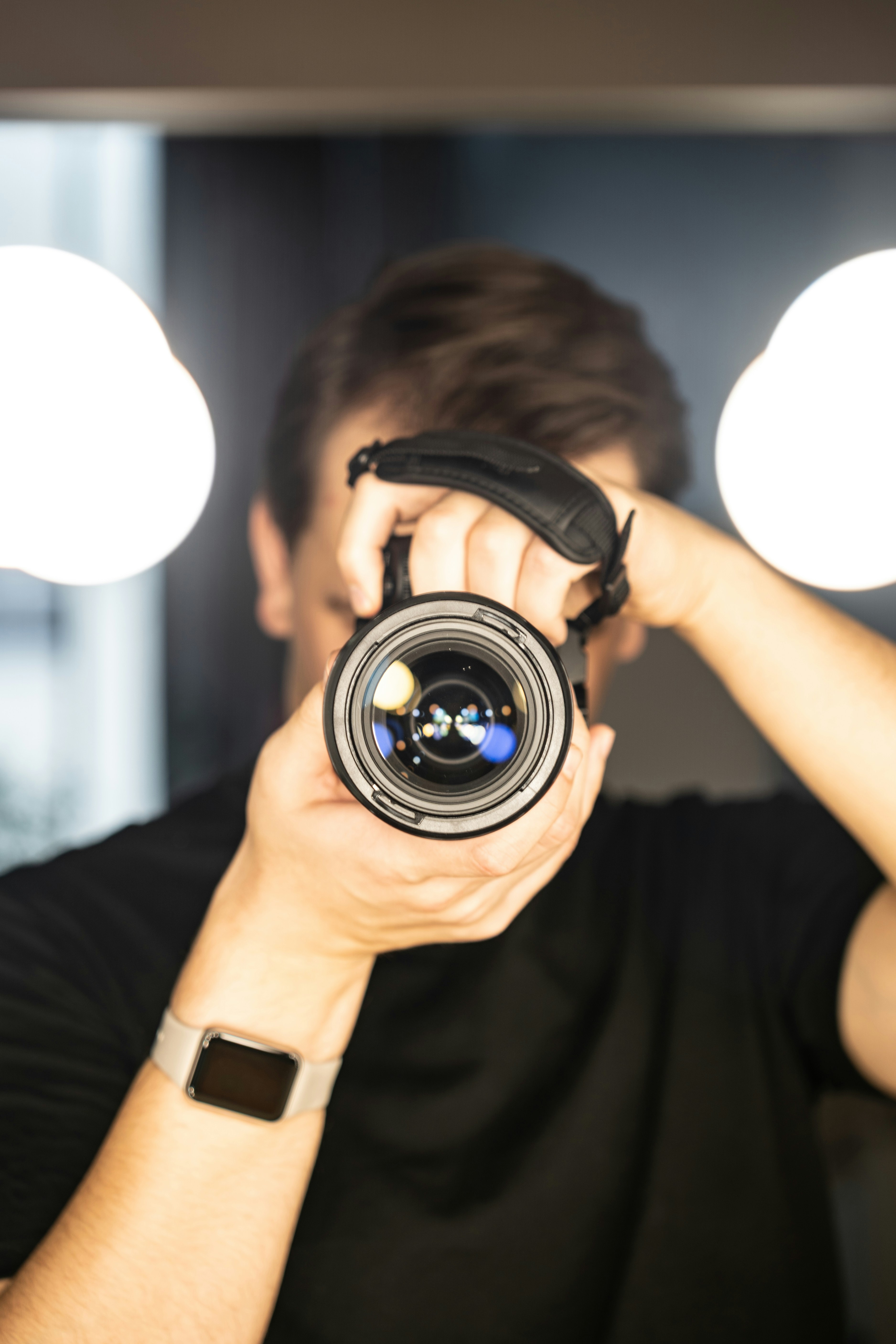 Mann, der eine Kamera ans Auge hält, hält eine Kamera an sein Auge