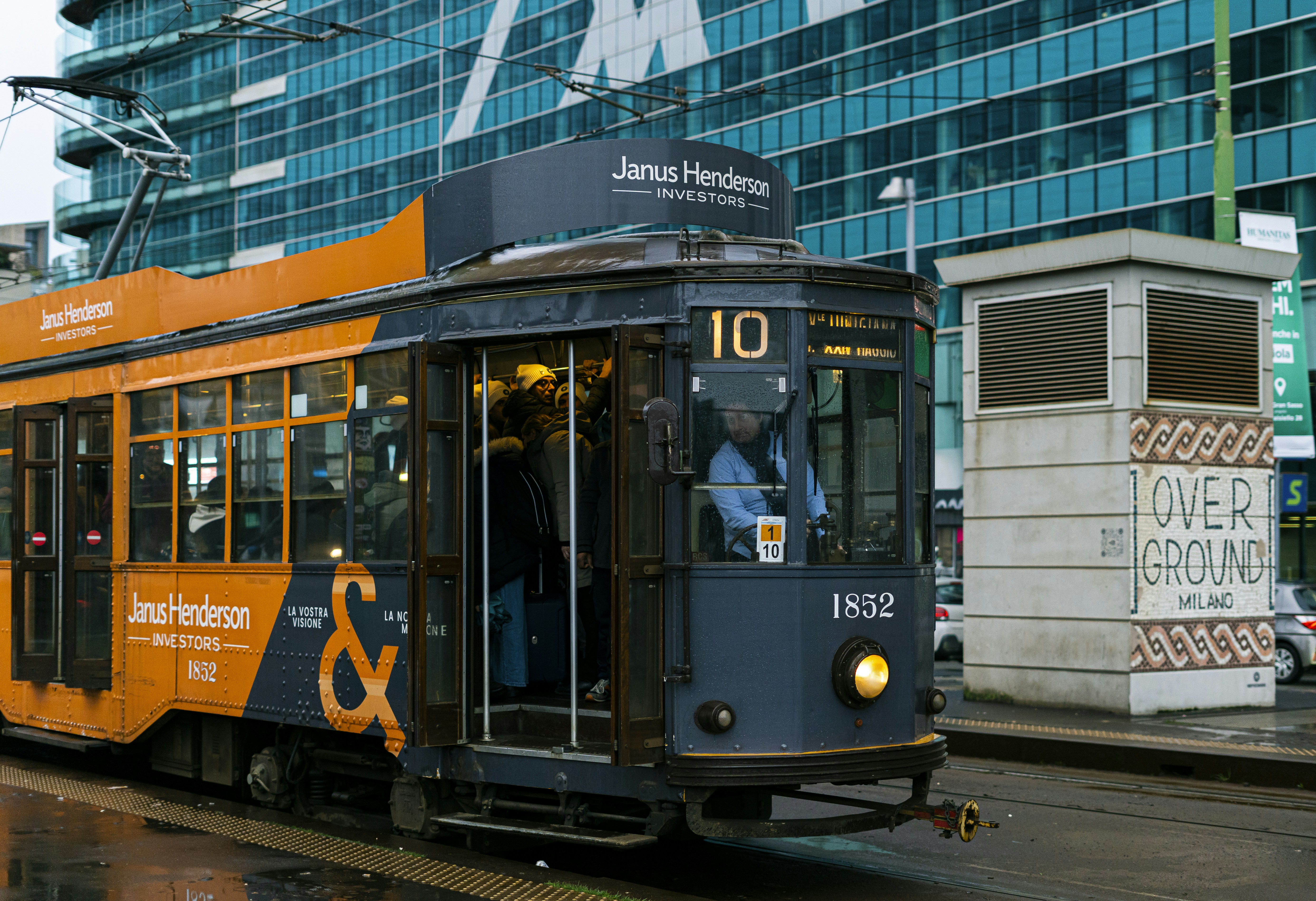 A vintage tram numbered 10 on a city street.