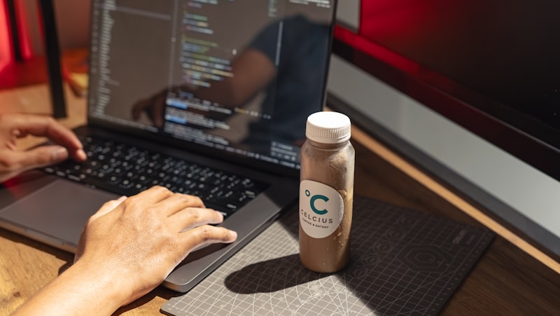 Person reviewing best tech news FeedCryptoBuzz on a laptop with coffee at a modern workspace