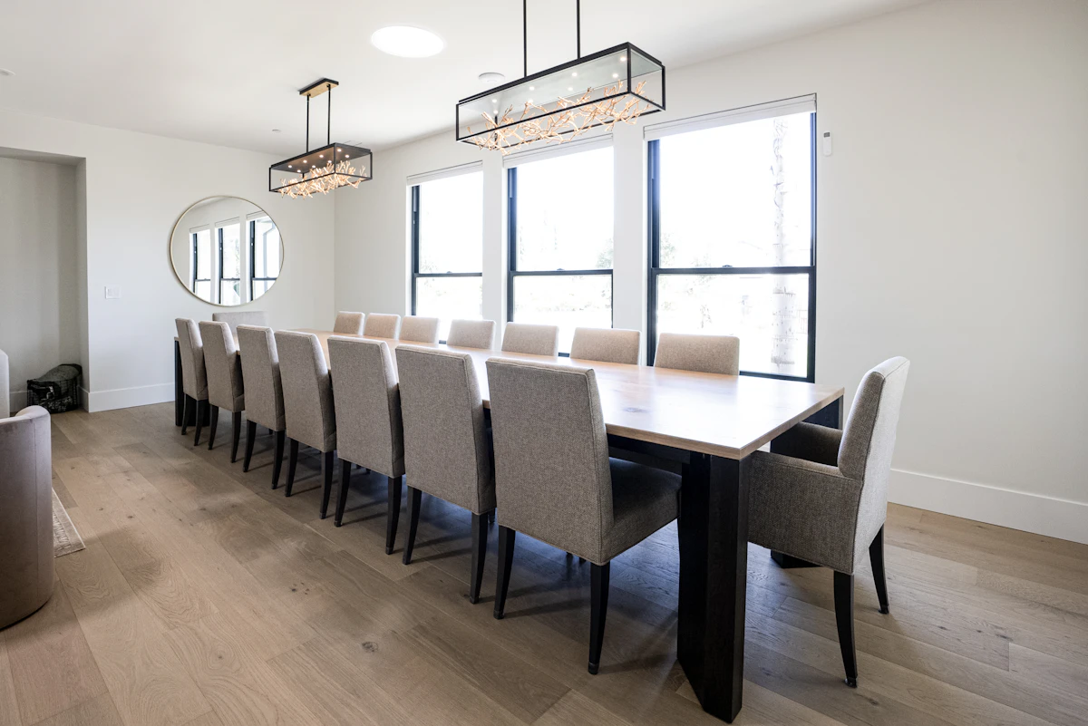 Long wood dining table in a bright dining room