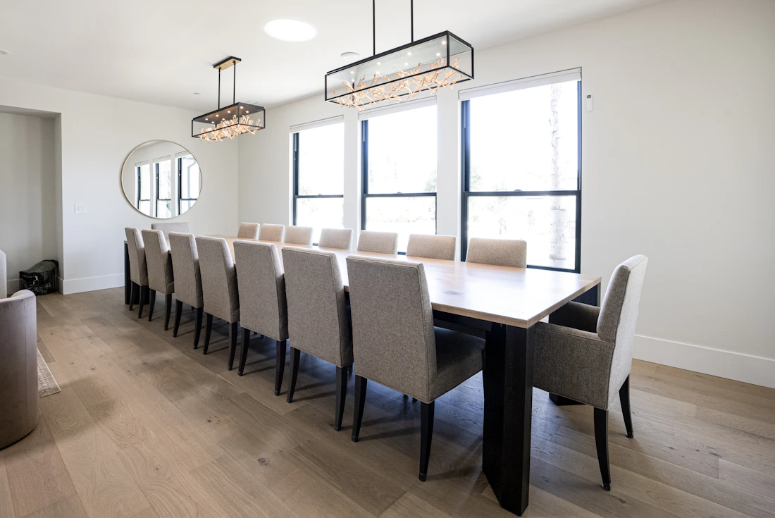 Bright modern dining room with a wooden dining table and upholstered chairs