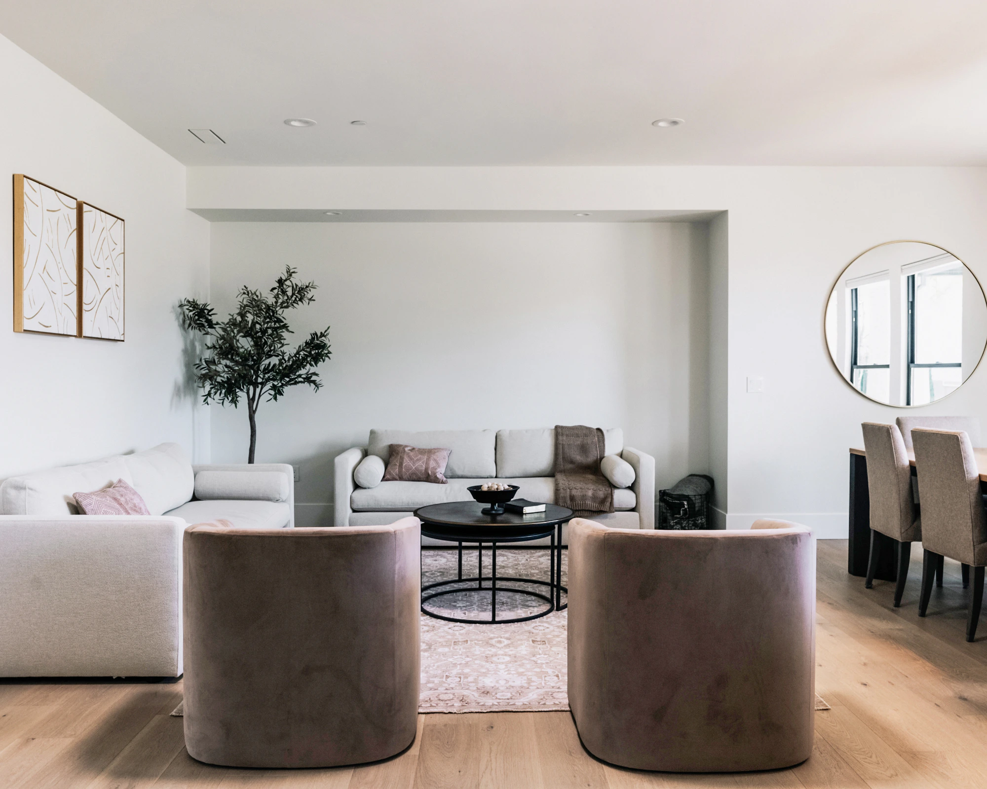 Contemporary living room with neutral furniture, soft textures, and warm interior styling