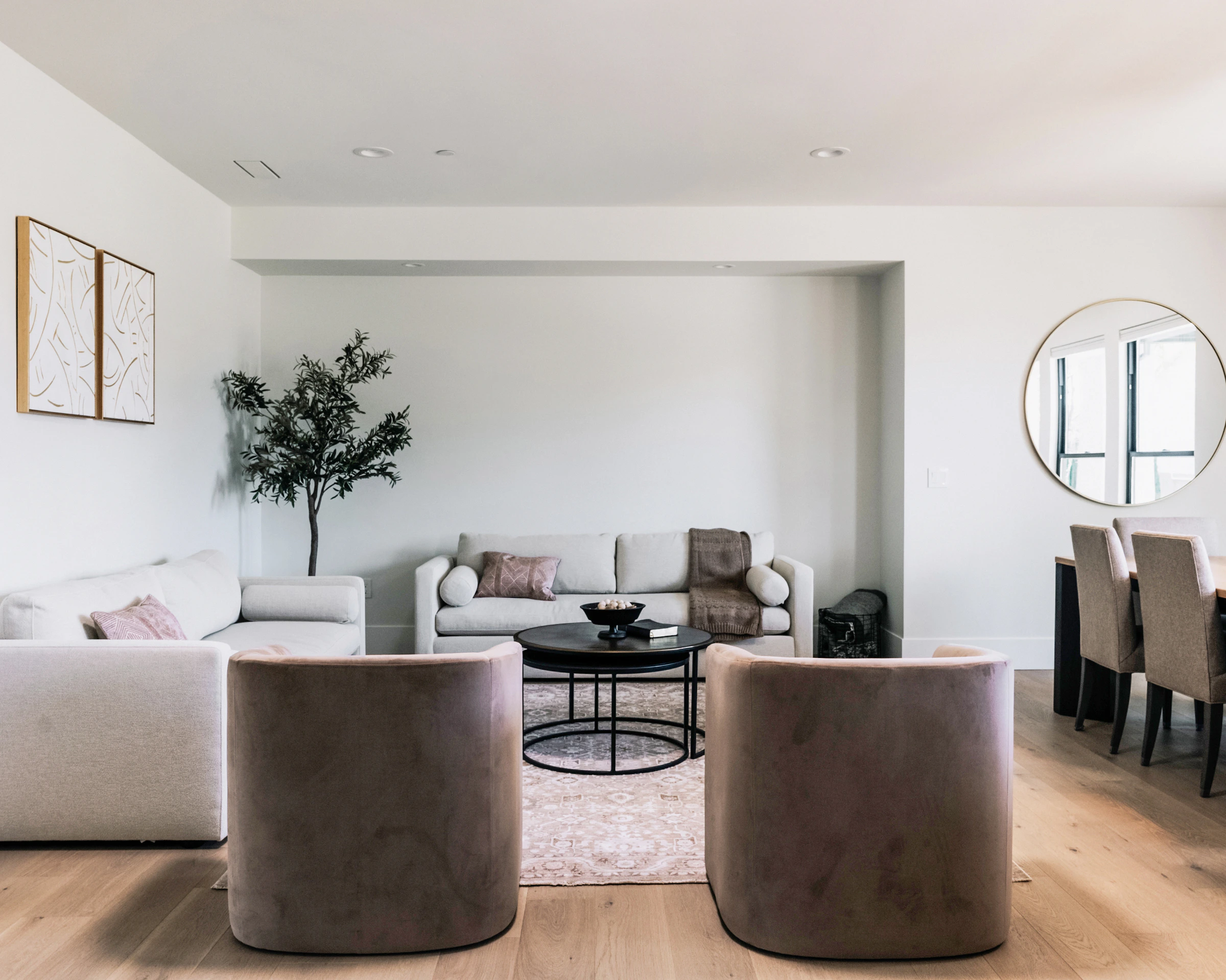 Refined living room with neutral furniture, sculptural seating and warm natural light