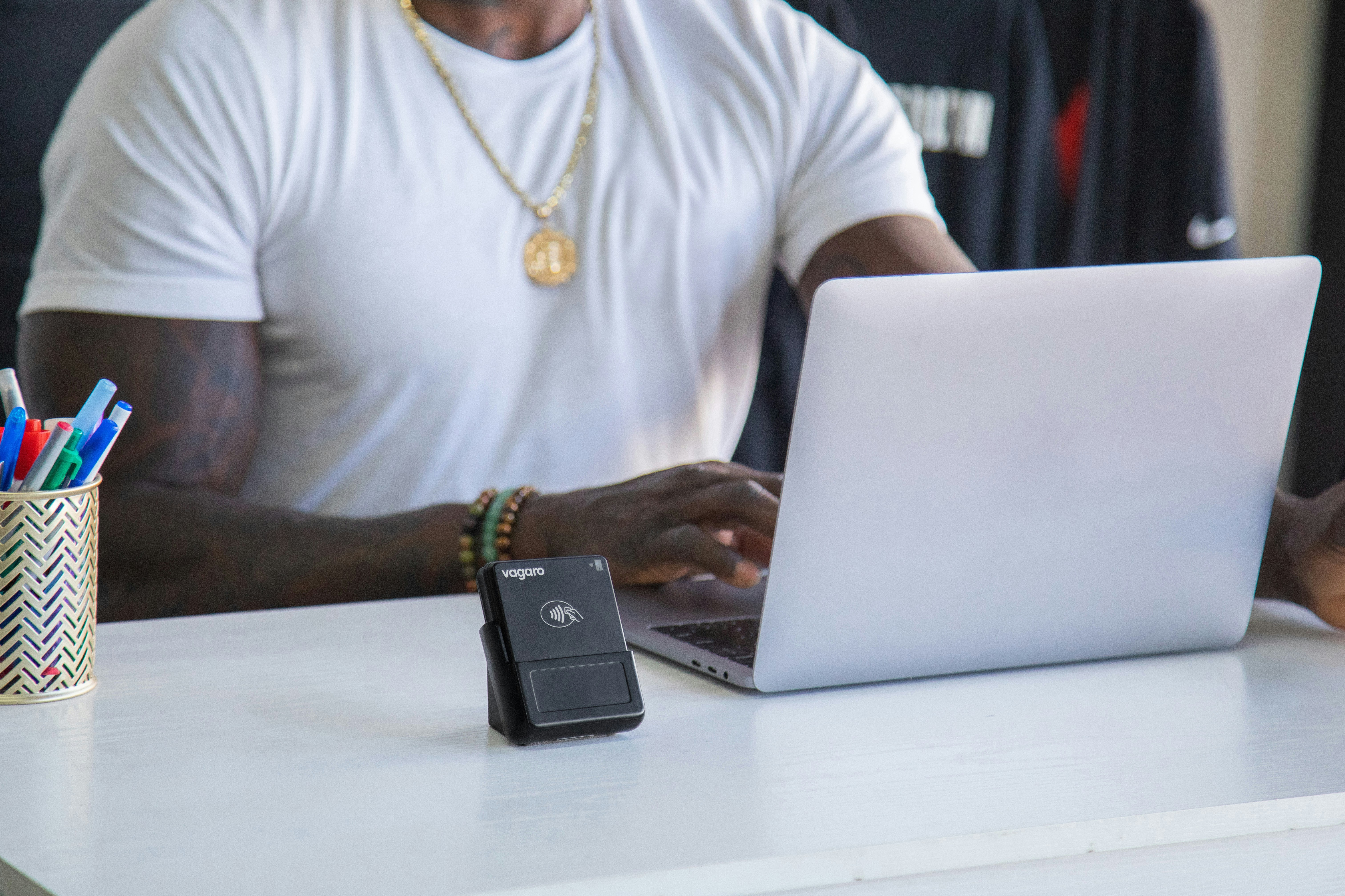 Man typing on a laptop at a desk