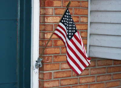 American flag attached to brick wall