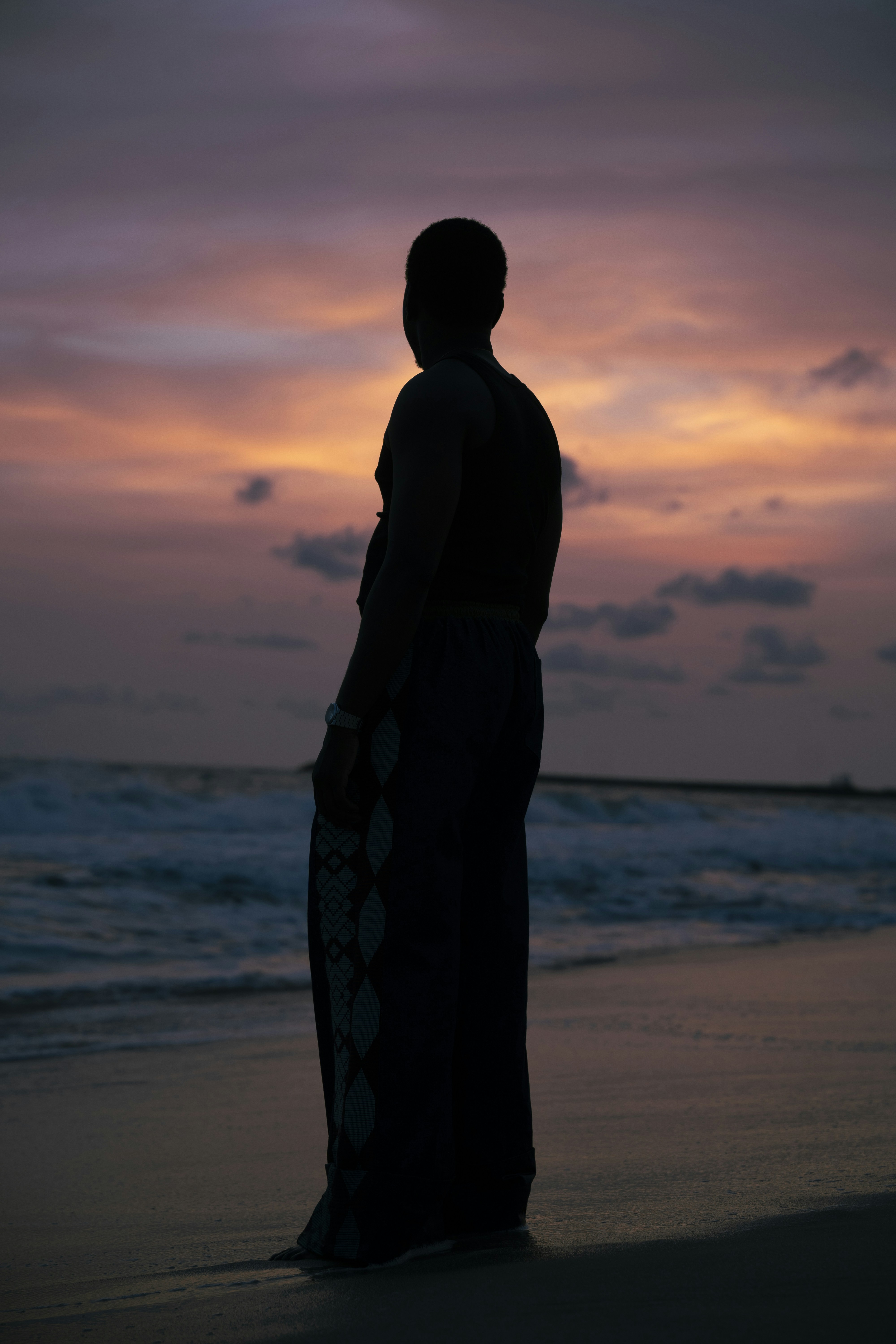 Silhouette of a person on a beach at sunset