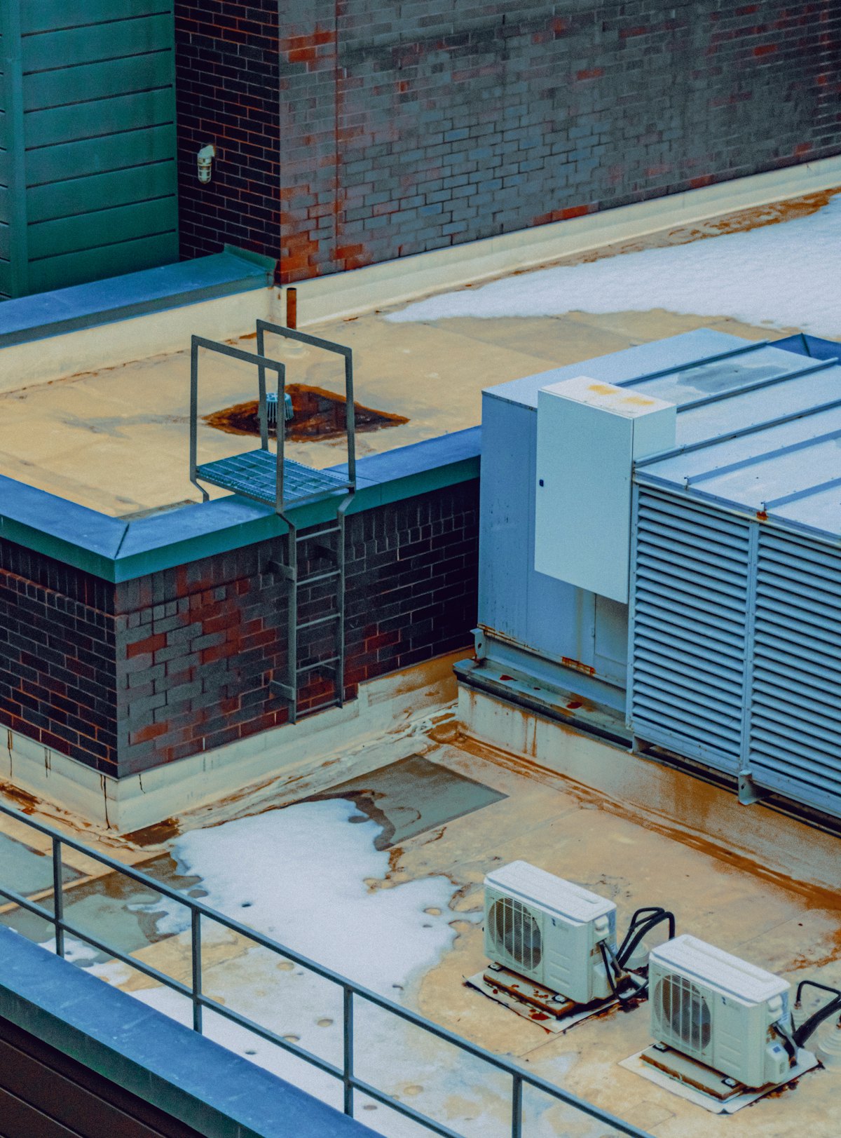 Commercial rooftop with mechanical units and access ladders