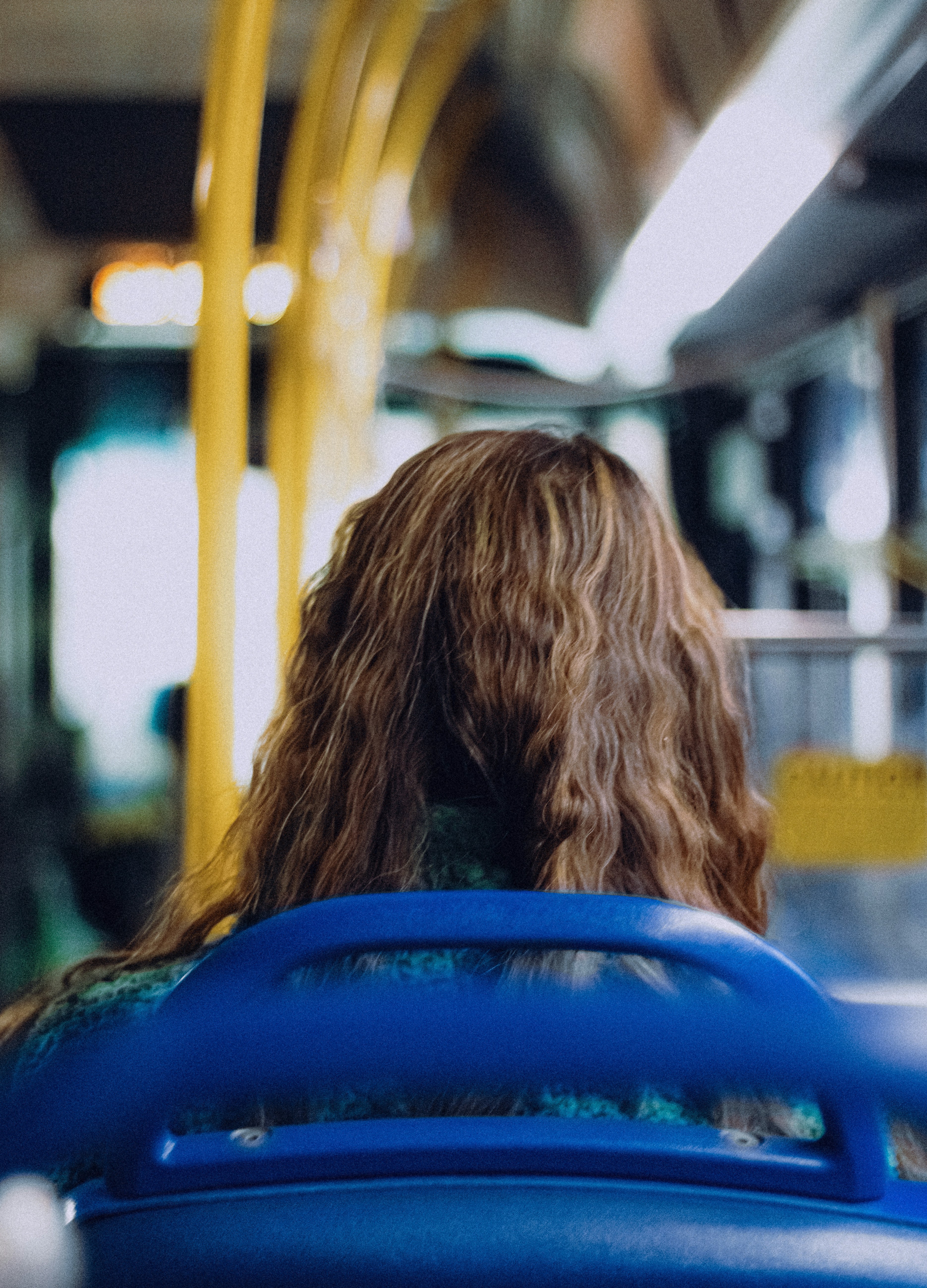 Woman with long brown hair on a bus