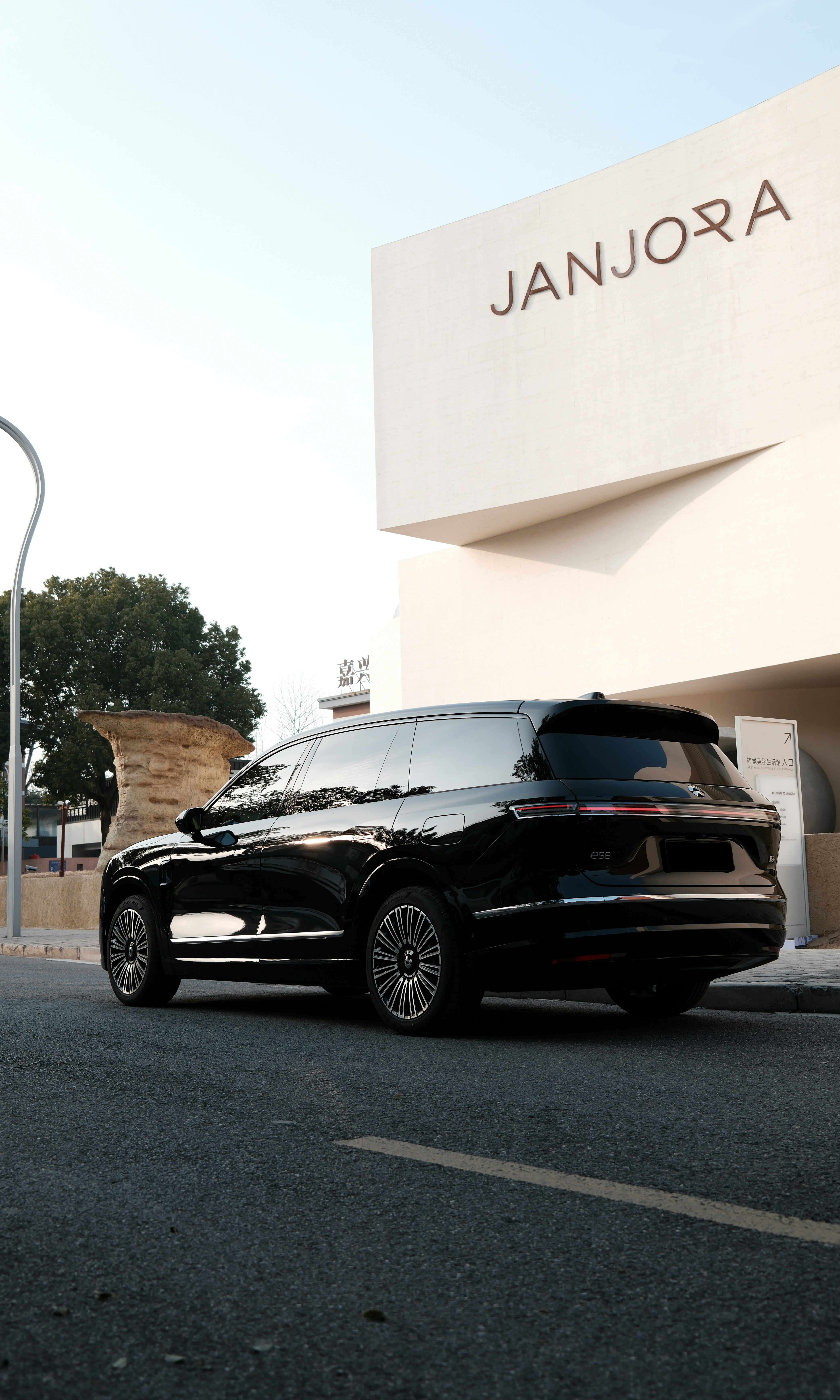 Black luxury suv parked by modern building.