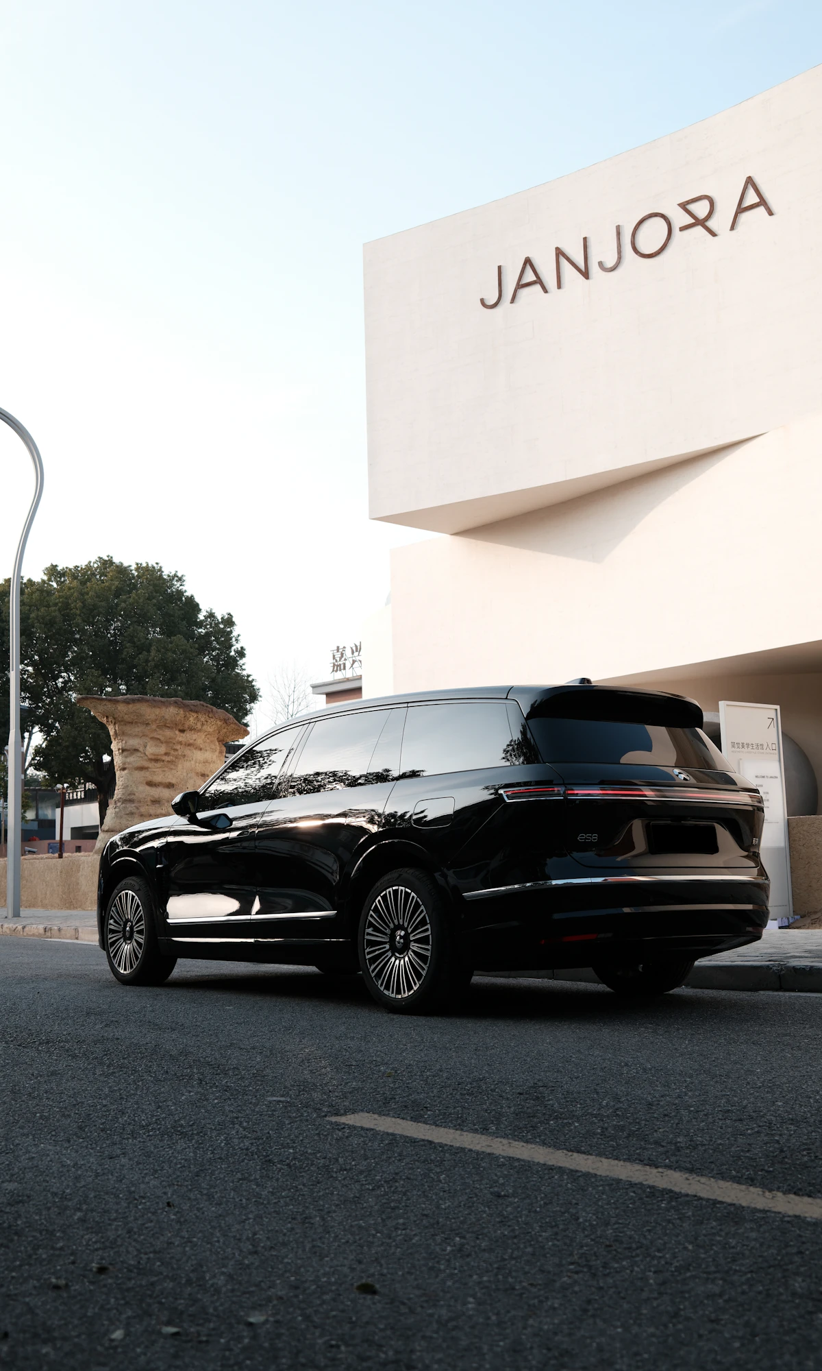 Black luxury SUV by a modern building