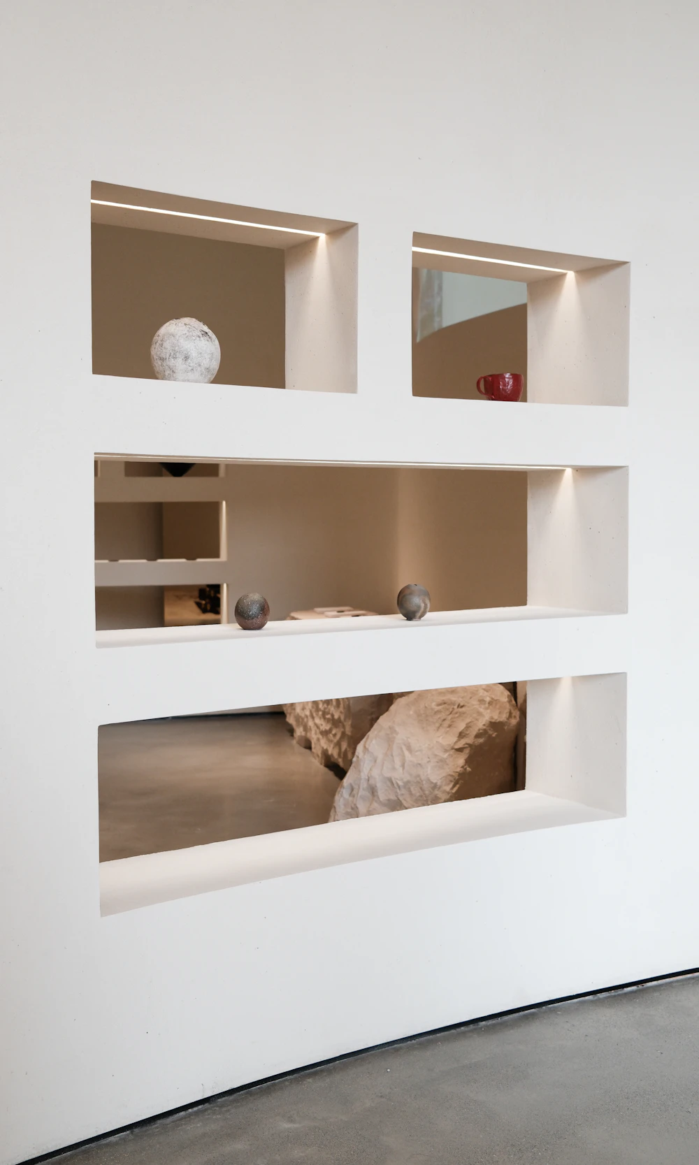 Decorative sculptural objects displayed in recessed wall niches