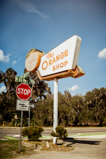 The orange shop roadside sign with stop sign