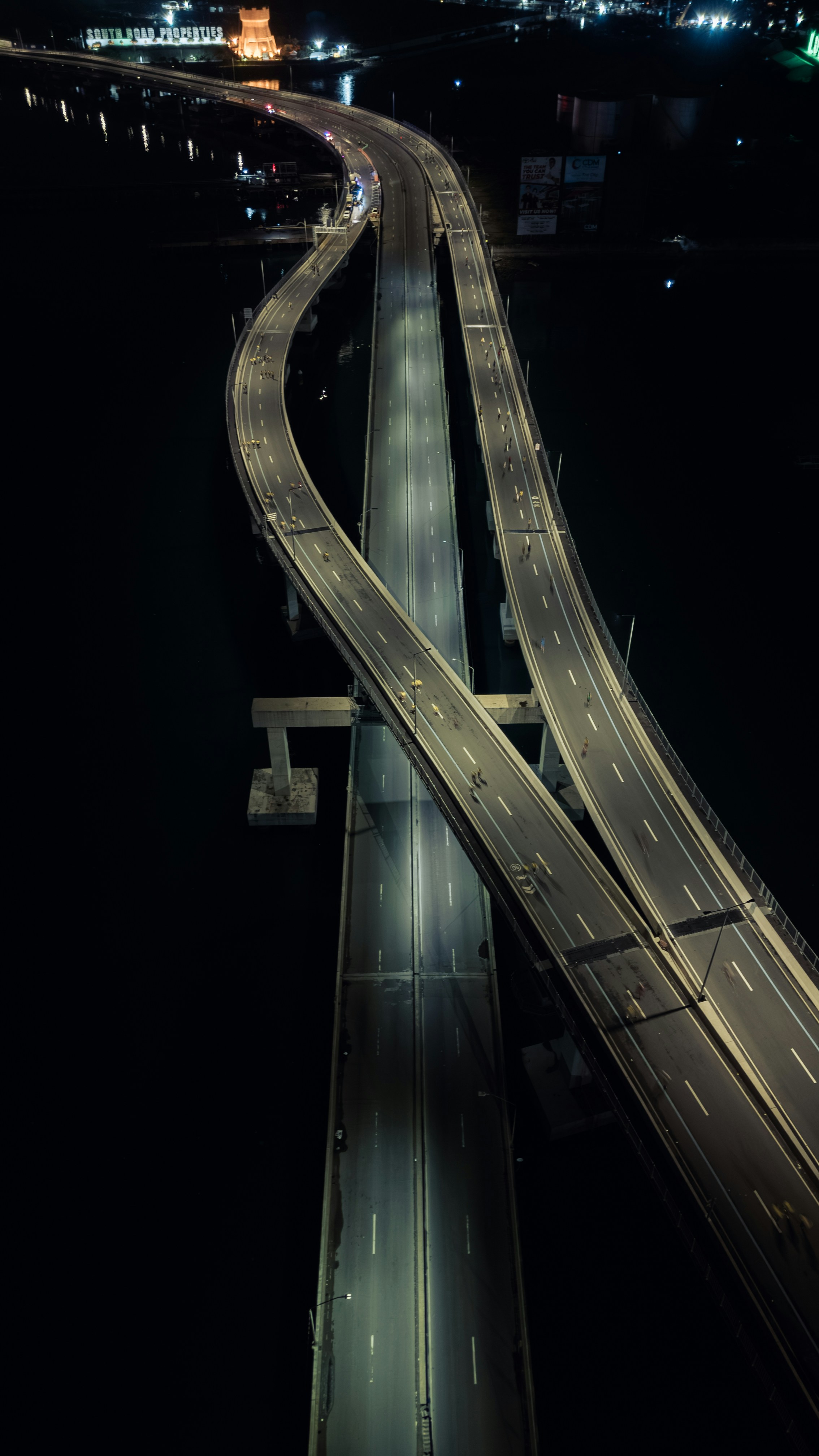Illuminated highway overpass at night with dark surroundings