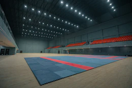Empty indoor sports arena with blue and red matting