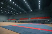 Empty indoor stadium with blue and red mat