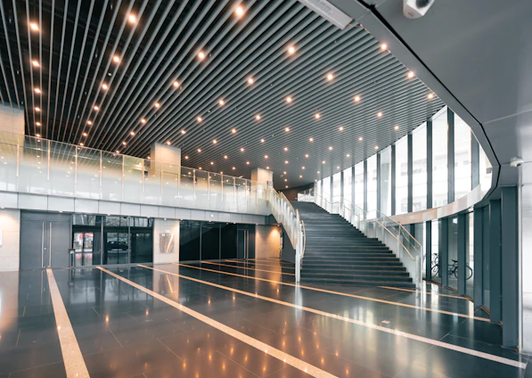 Modern interior with a grand staircase and bright lighting.