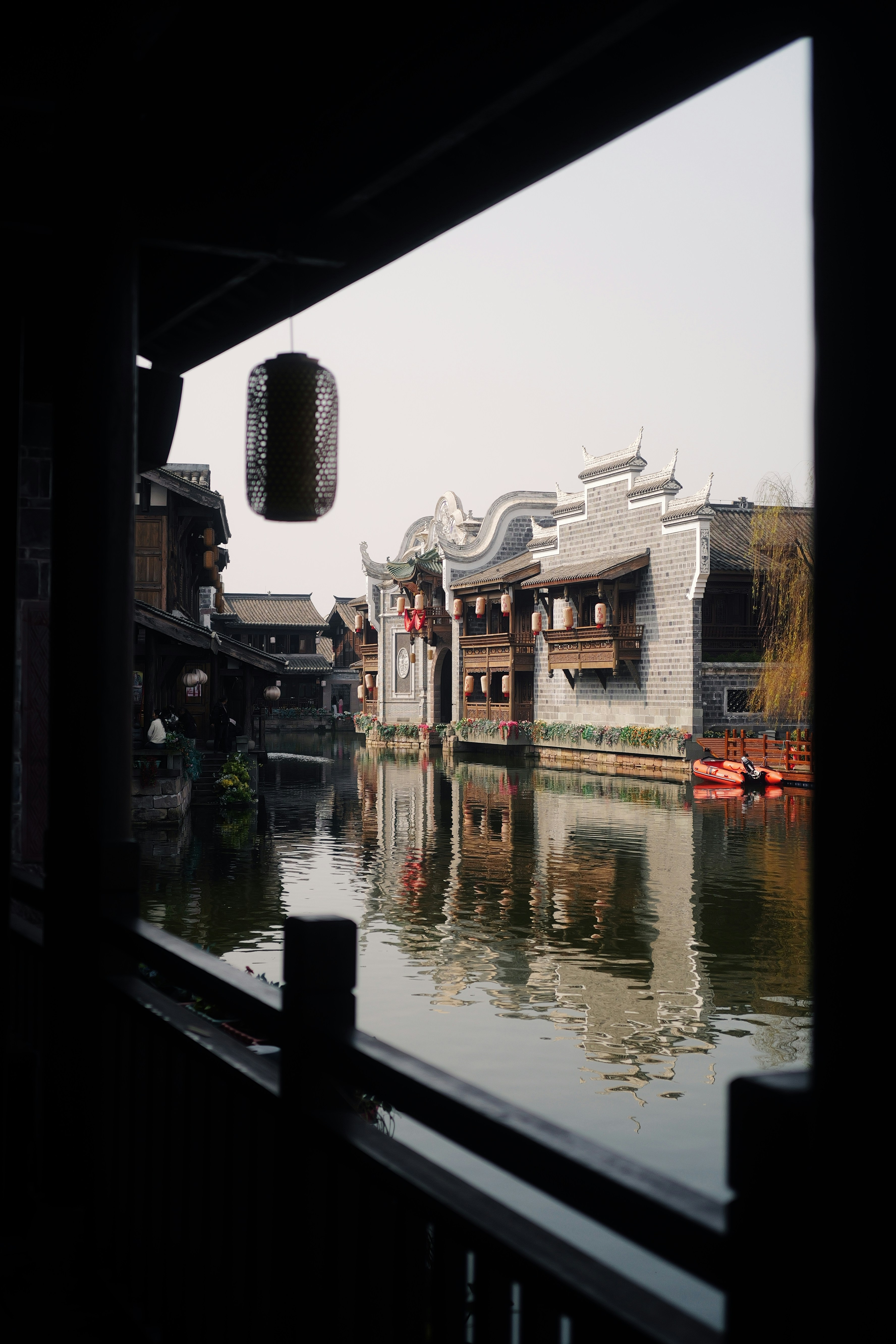 Traditional chinese buildings reflected in a calm canal.