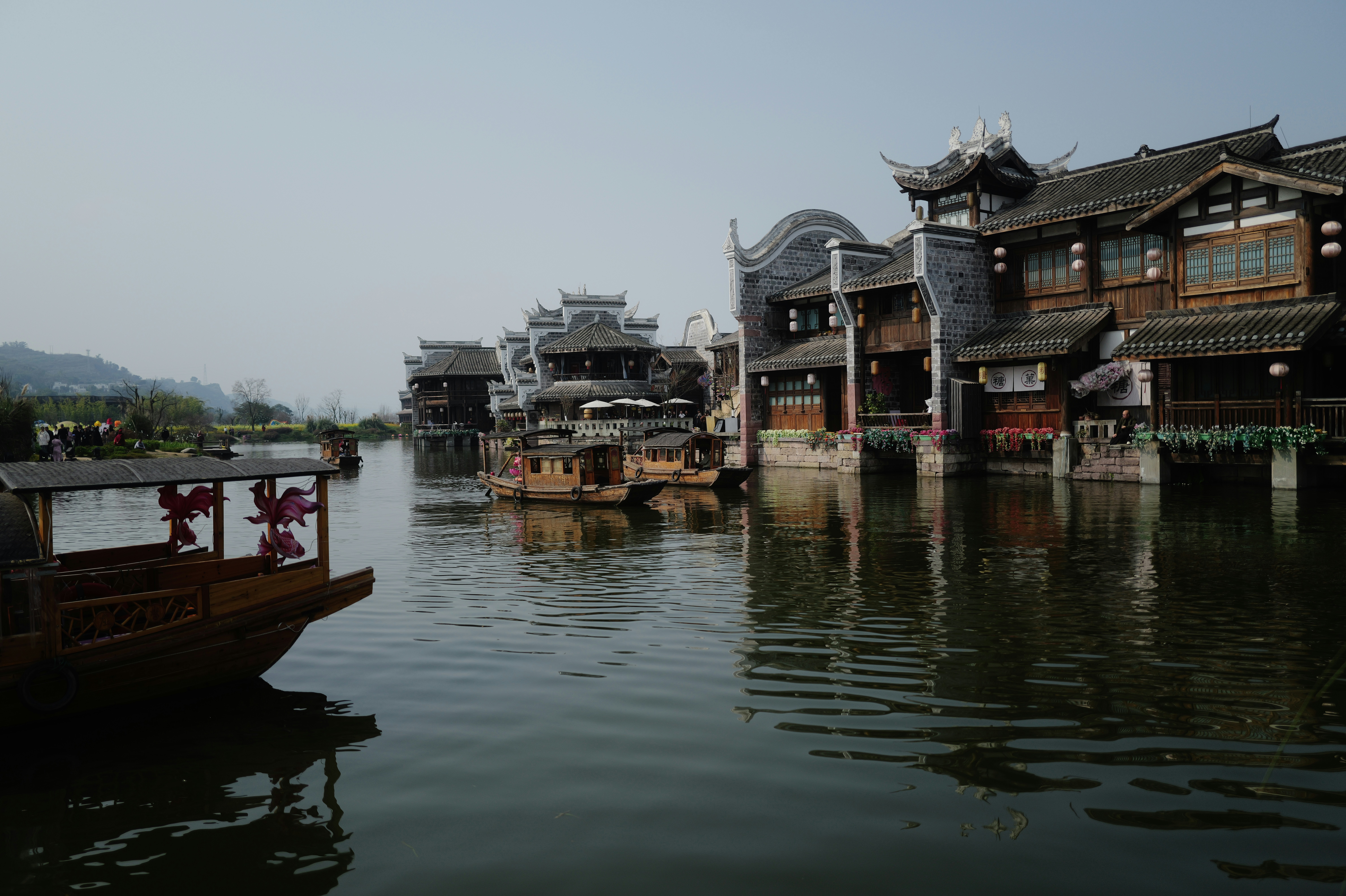 Traditional boats on a canal with historic buildings.