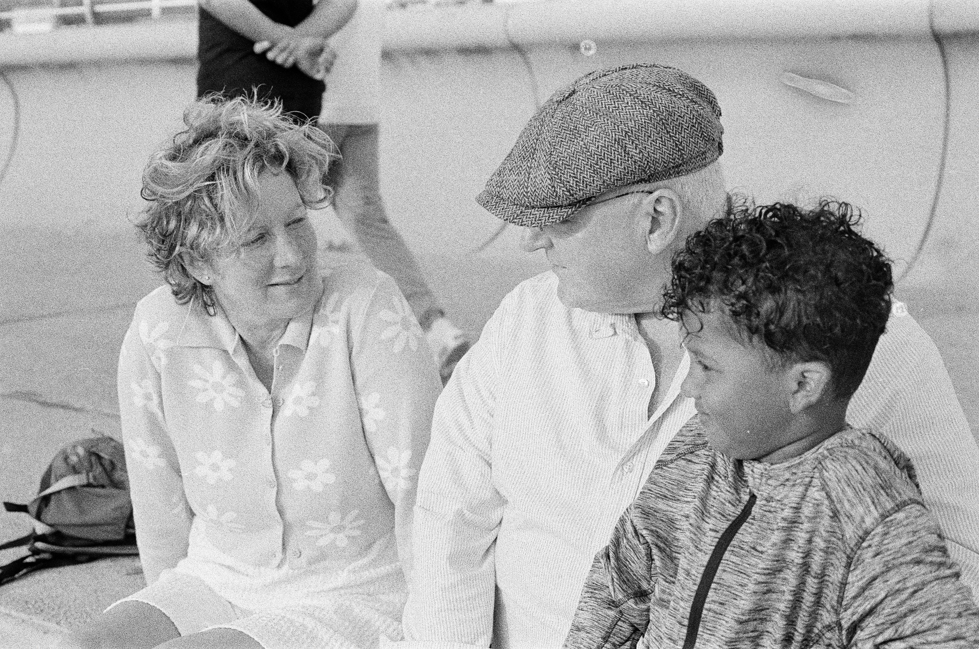 An older couple and a young boy talking