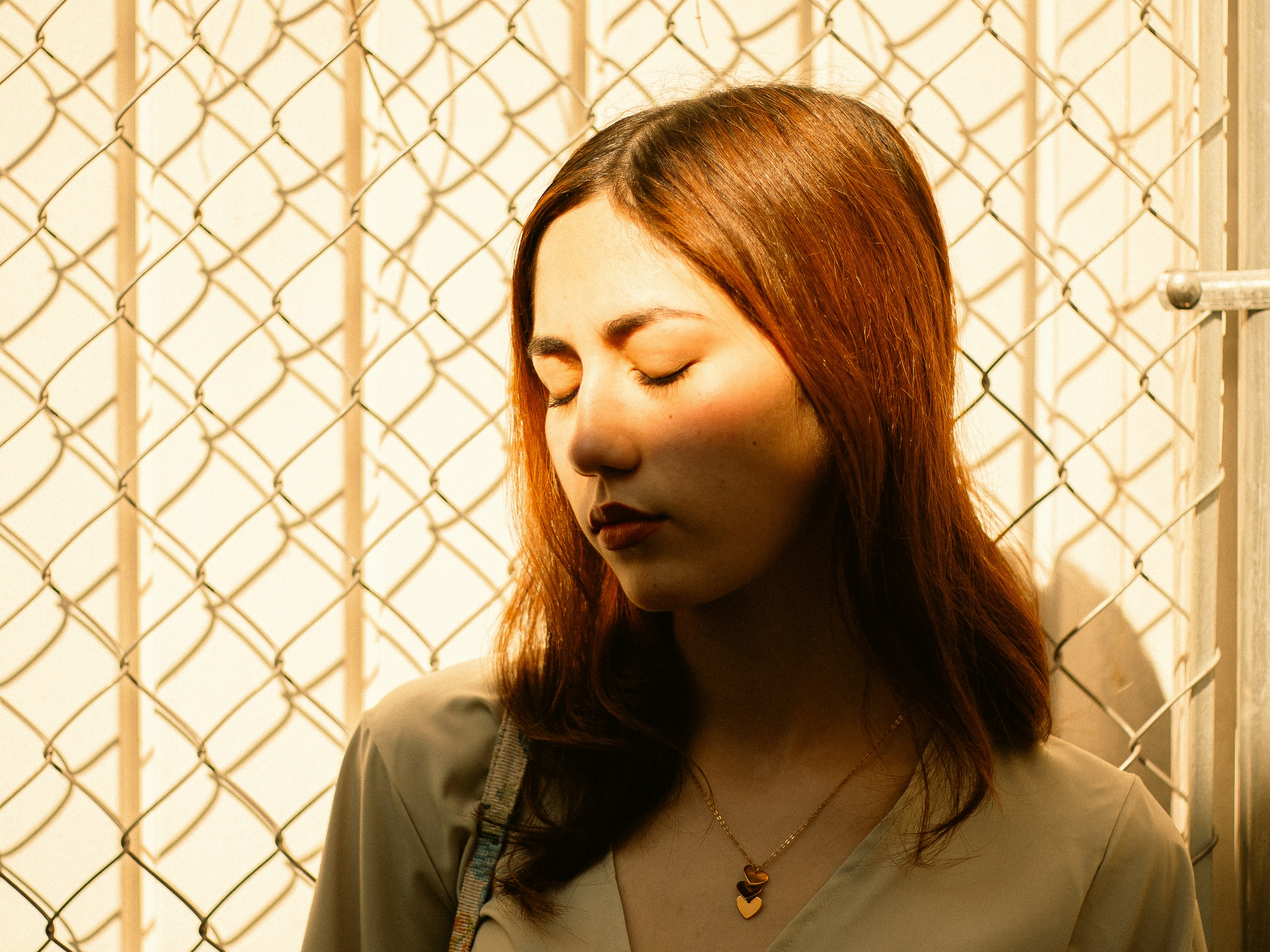 A young woman with eyes closed in sunlight