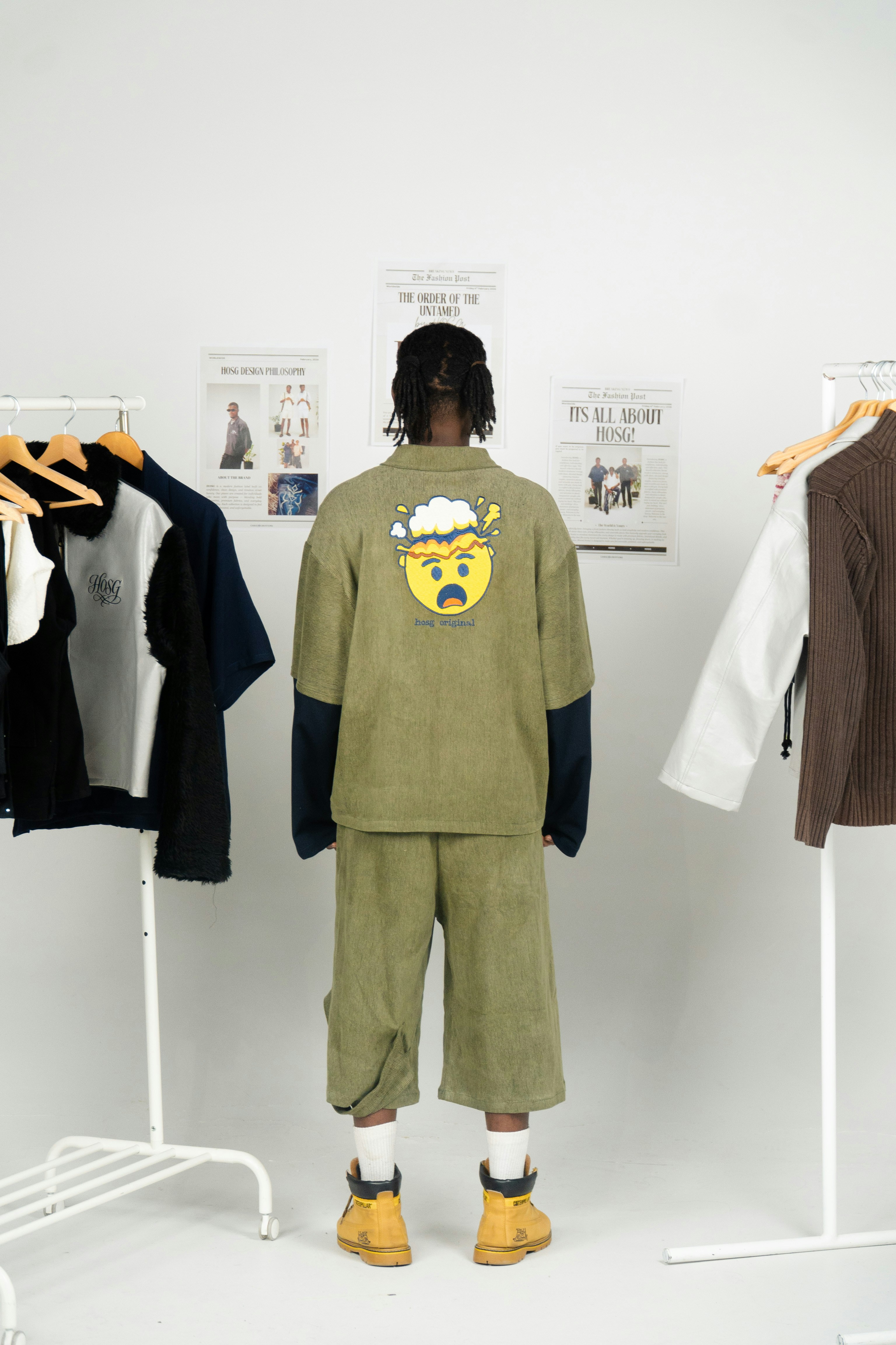 Man wearing an oversized green outfit with cartoon graphic