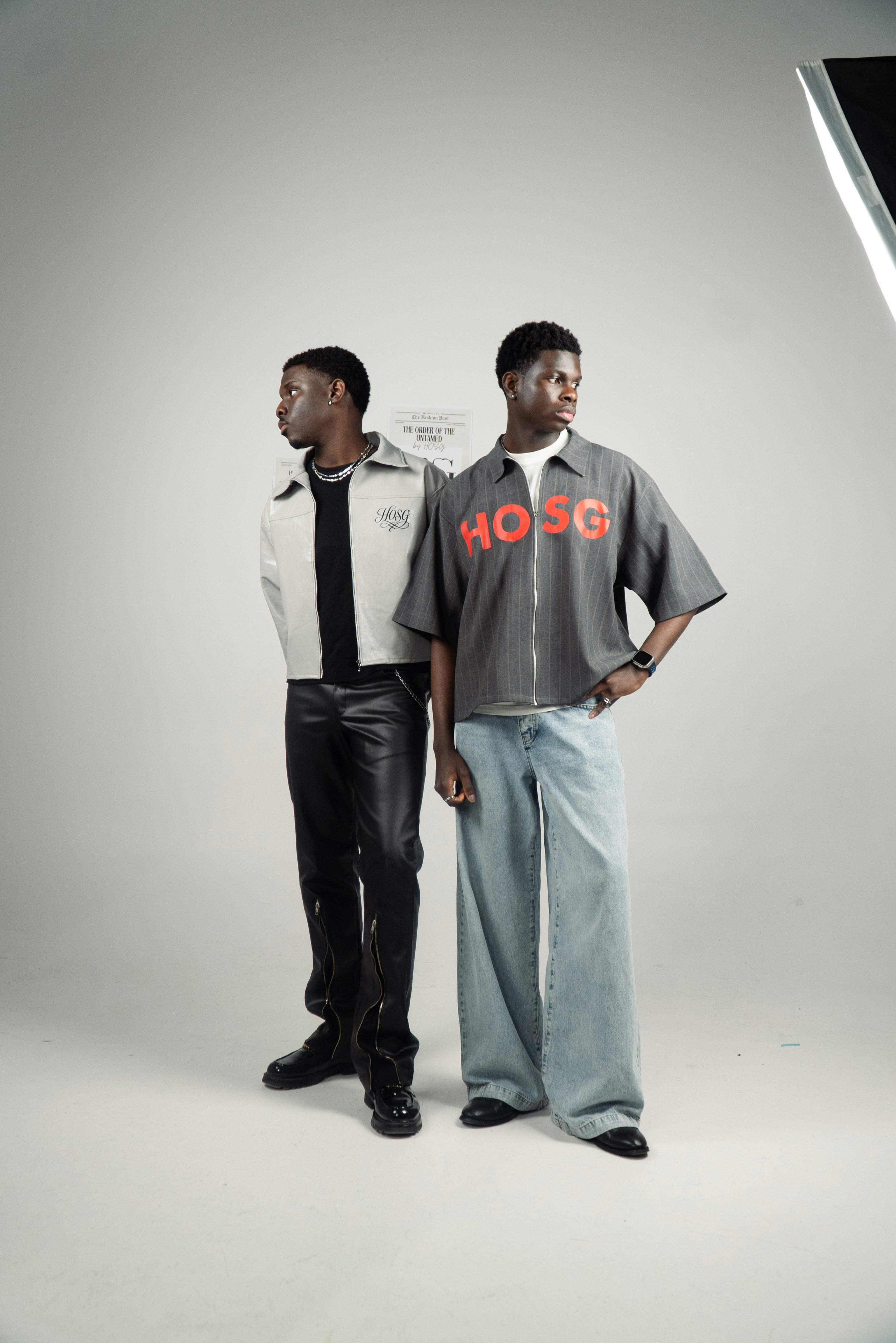 Two young men posing in a studio setting