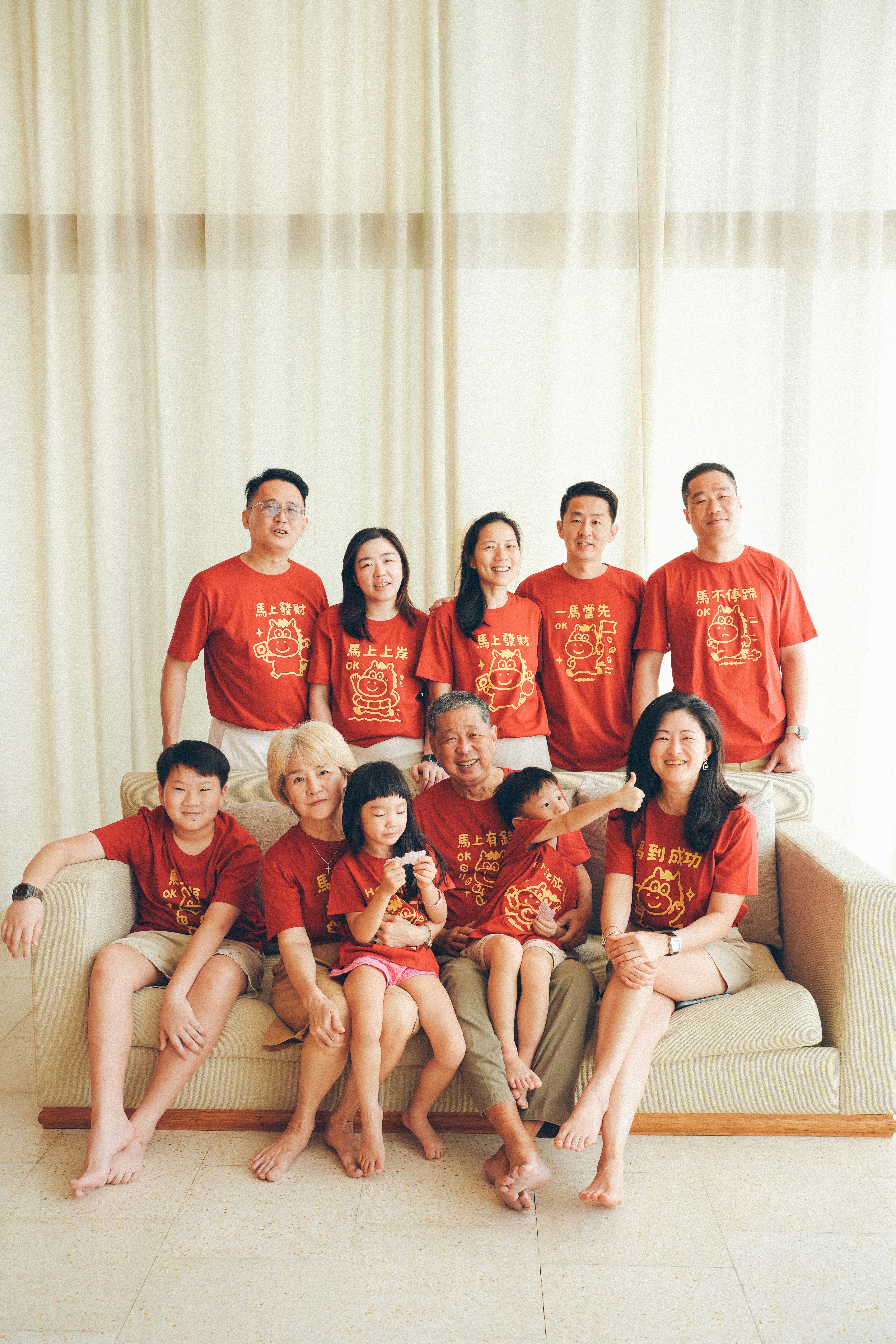 A multi-generational family wearing matching red shirts.
