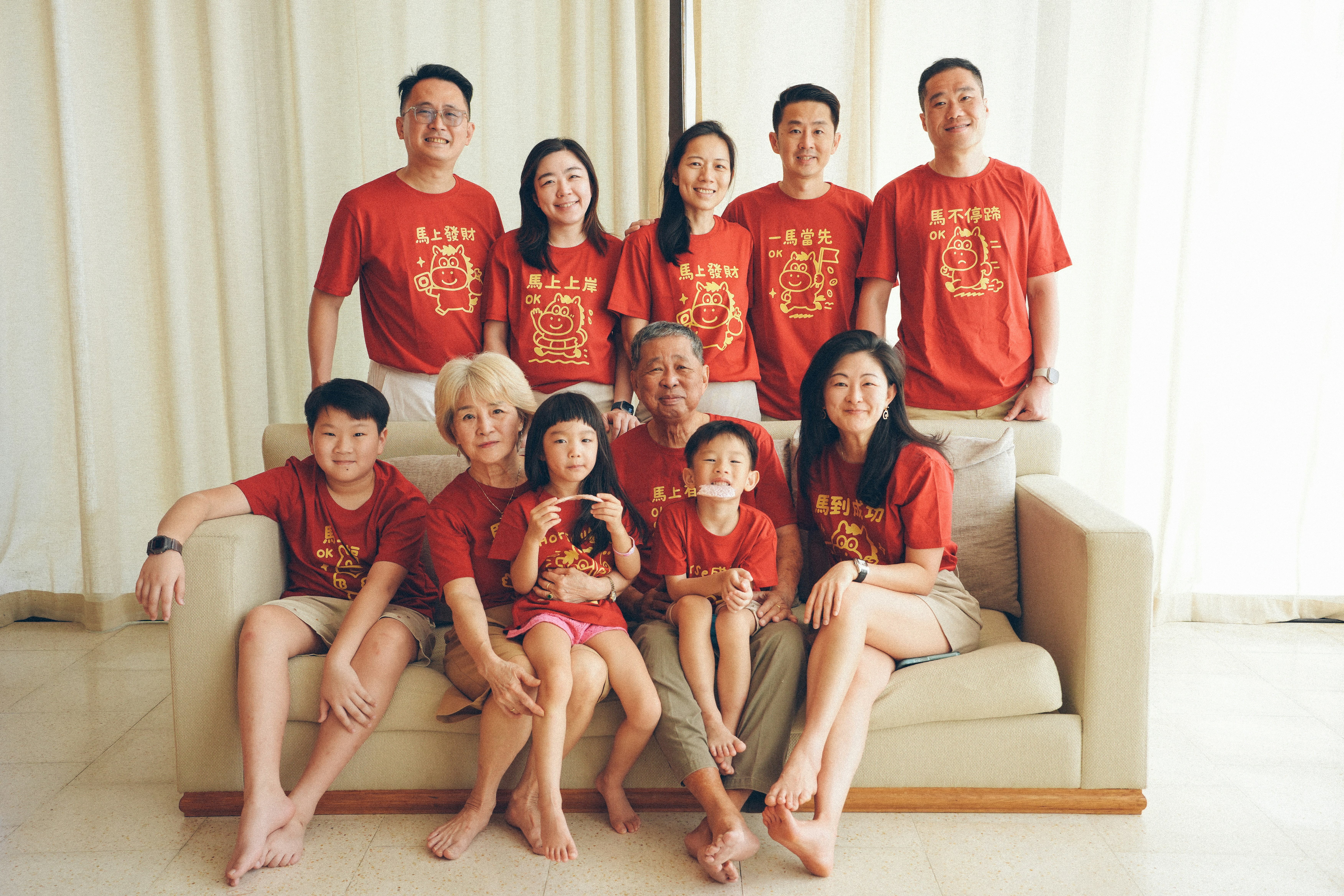 A multi-generational family in matching red shirts