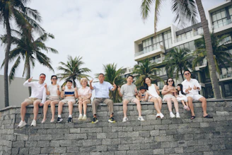 A group of people sitting on a stone wall