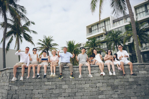 A group of people sitting on a stone wall