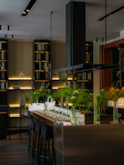 Modern kitchen island with bar stools and bookshelves