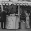 People at a dutch herring stand