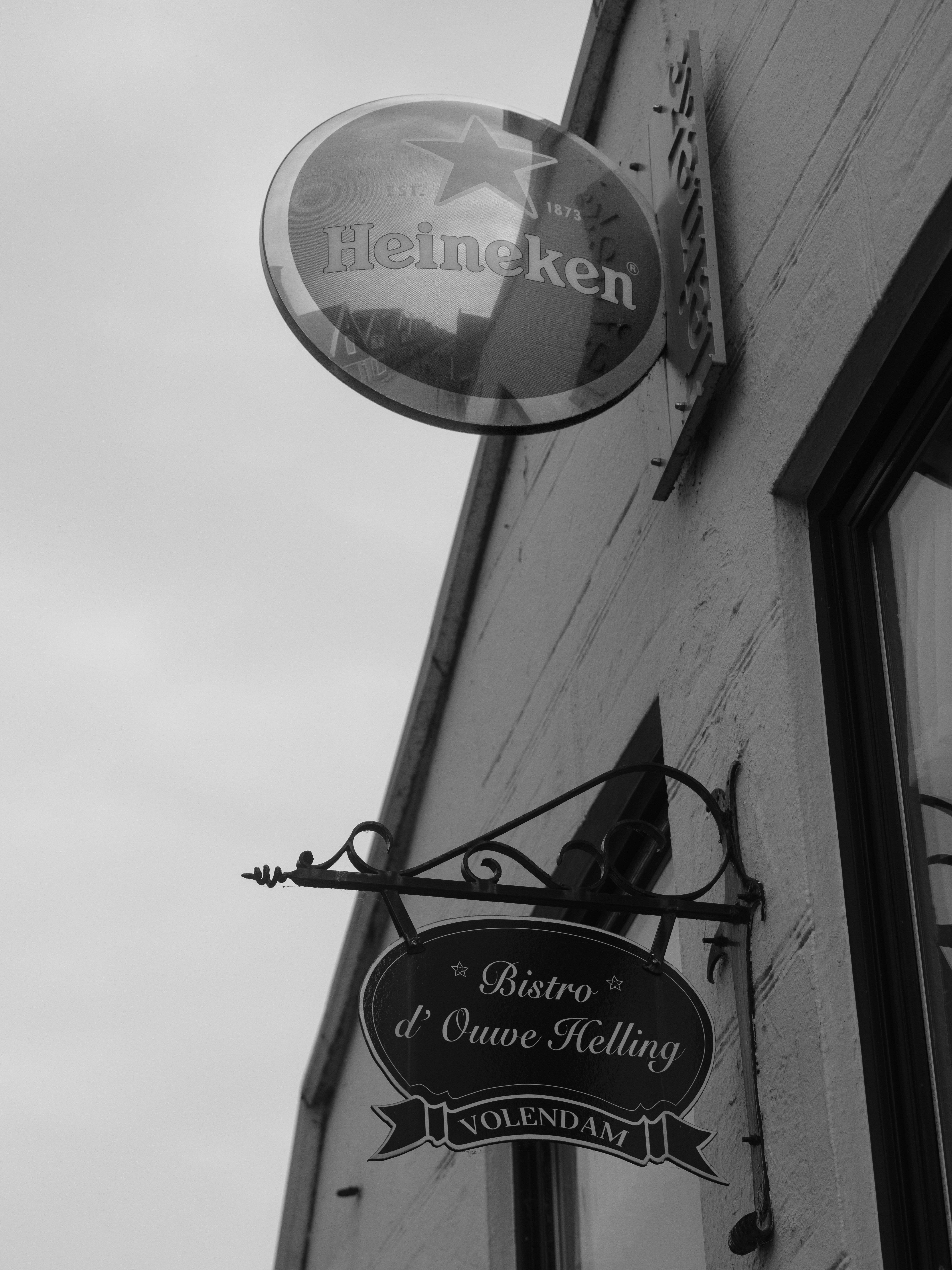 Heineken sign above a bistro sign