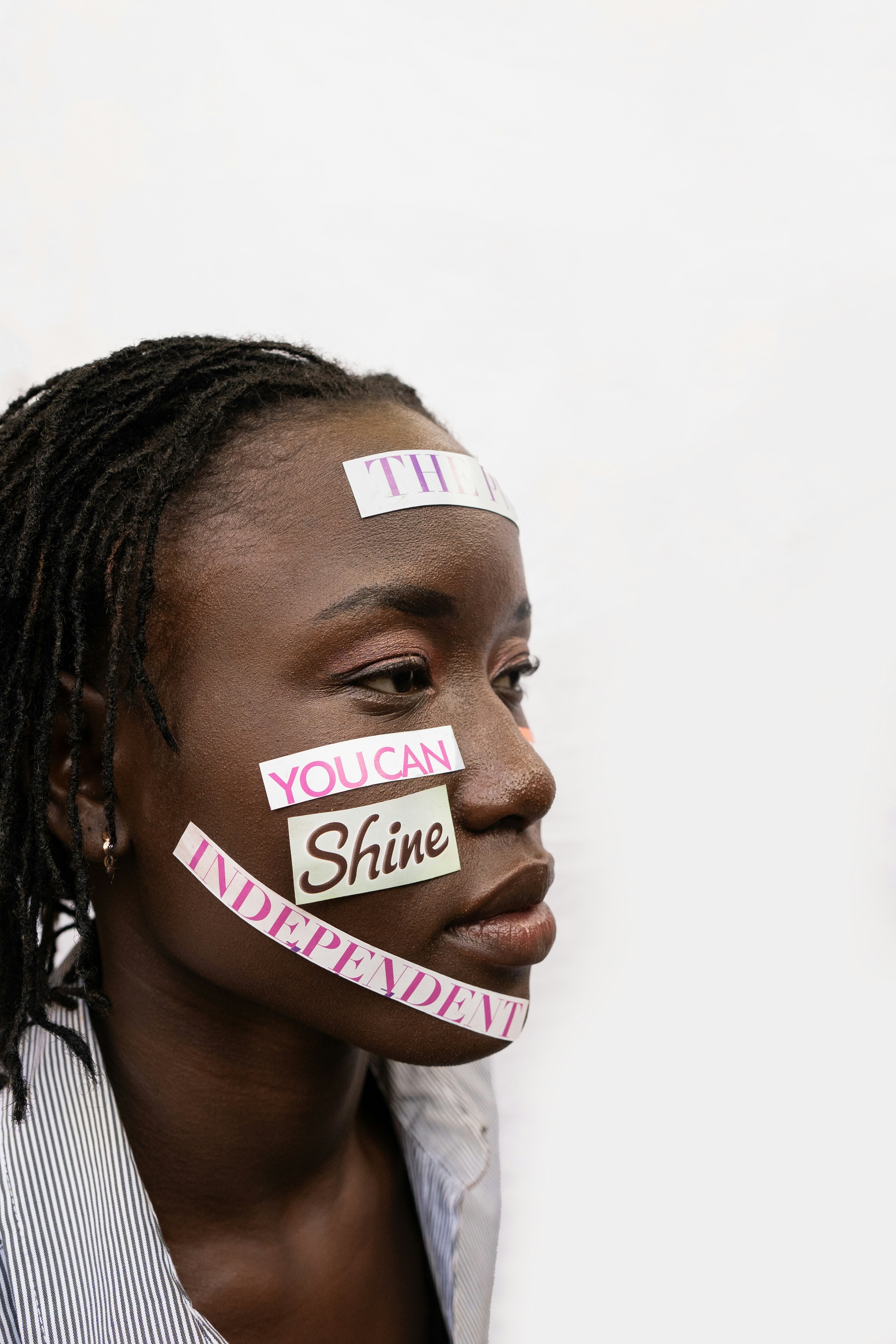 Woman with inspirational words taped to her face.