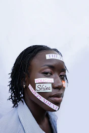 Woman with words "you can shine independent" on face