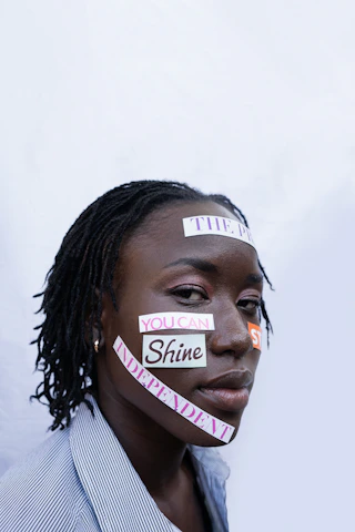 Woman with words "you can shine independent" on face