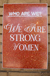 Poster reads 'who are we? we are strong women'.