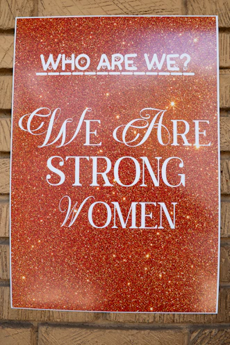 Poster reads 'who are we? we are strong women'.