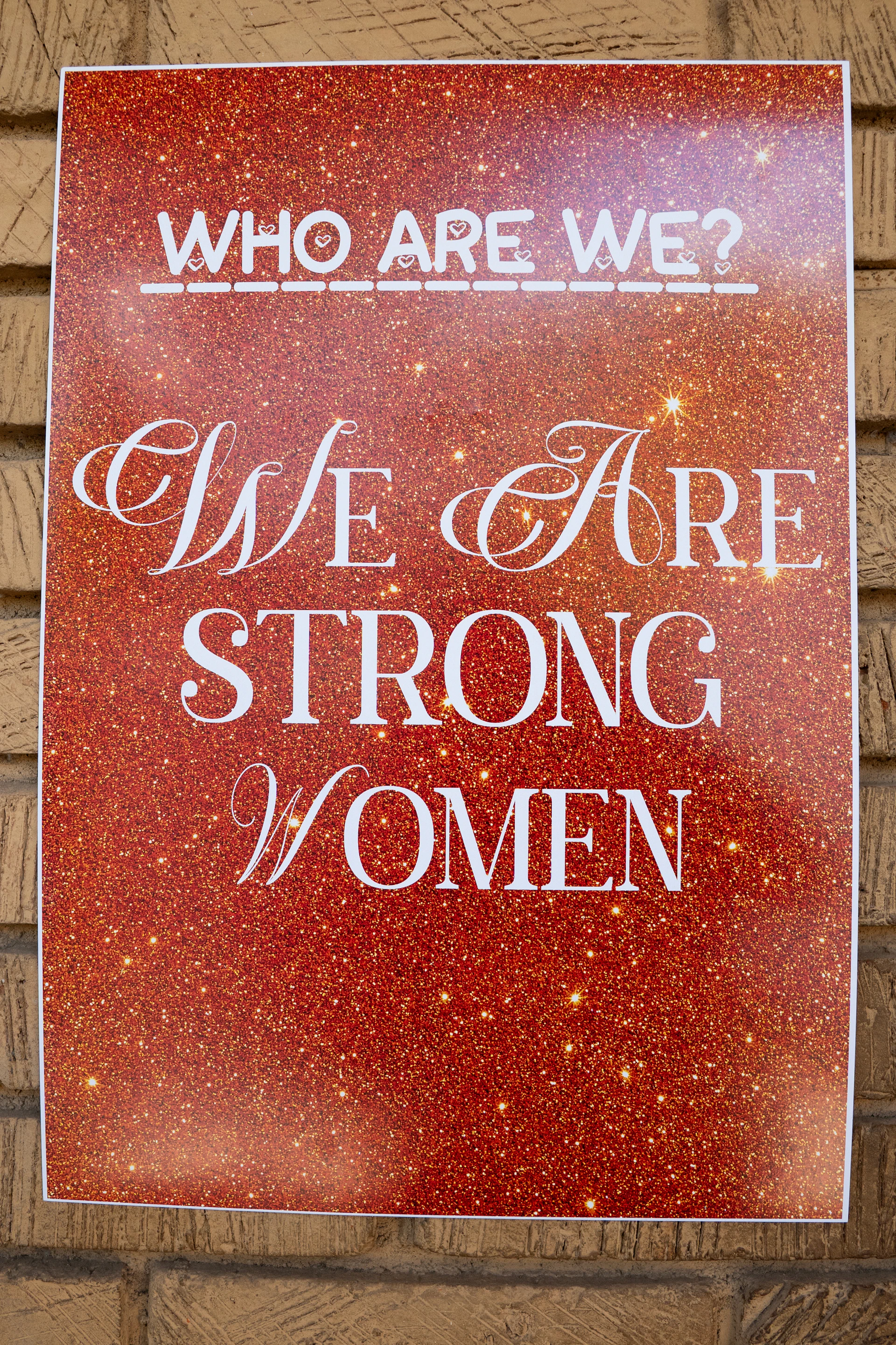 Poster reads 'who are we? we are strong women'.